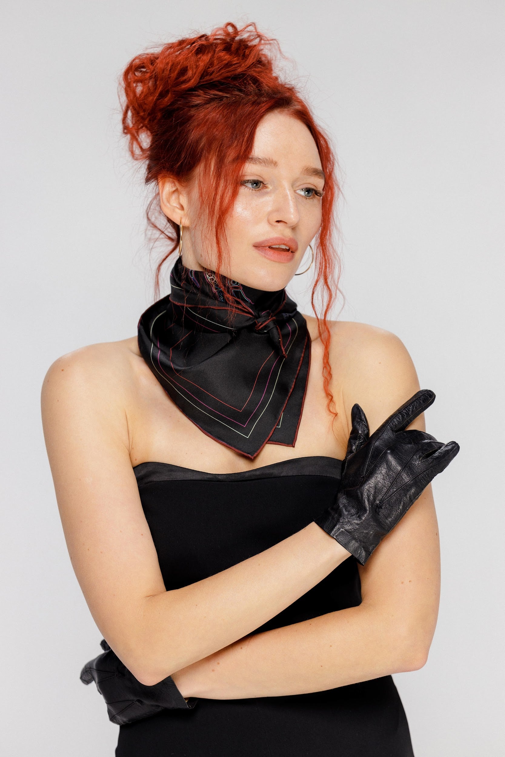 Model wearing silk twill square scarf around neck