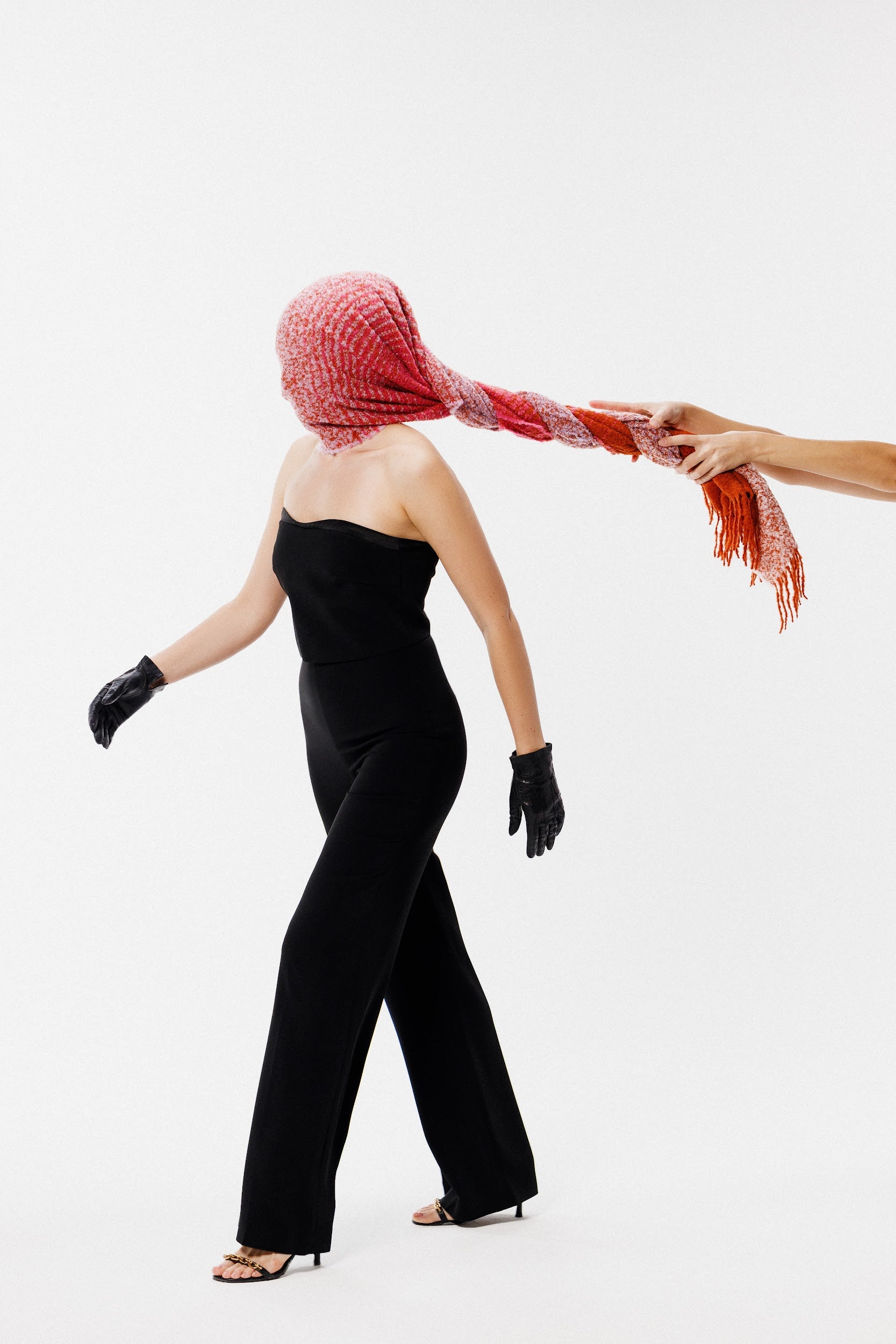 Person with alpaca wool winter scarf in pink lilac orange colors