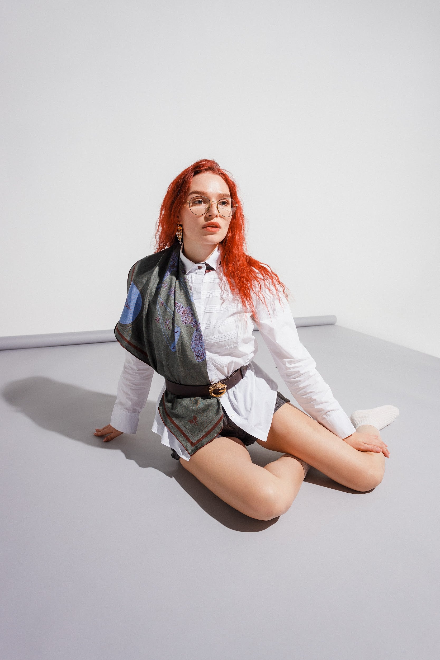 Model styling silk twill square scarf over shoulder