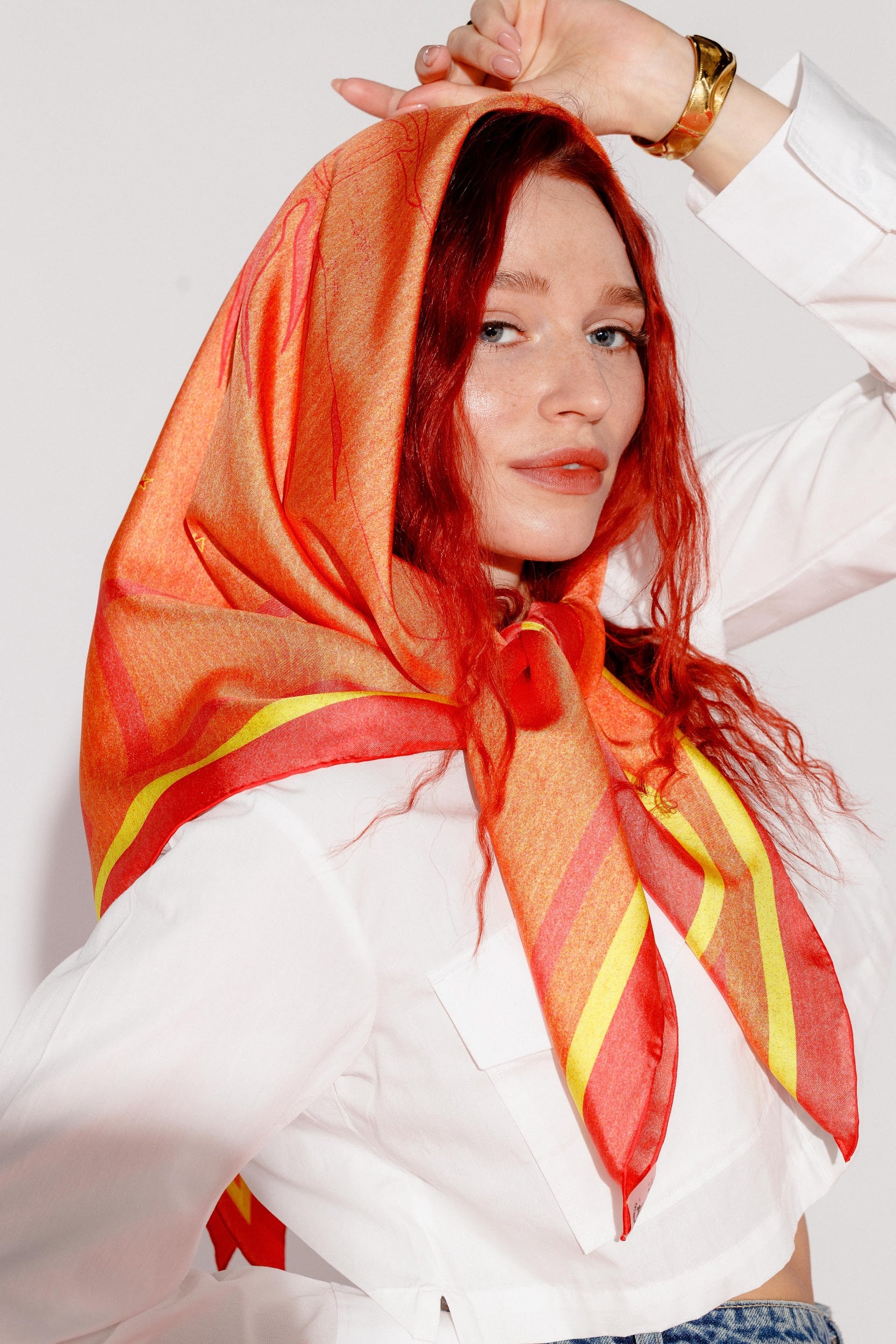 Model wearing silk twill square scarf as bandana around head