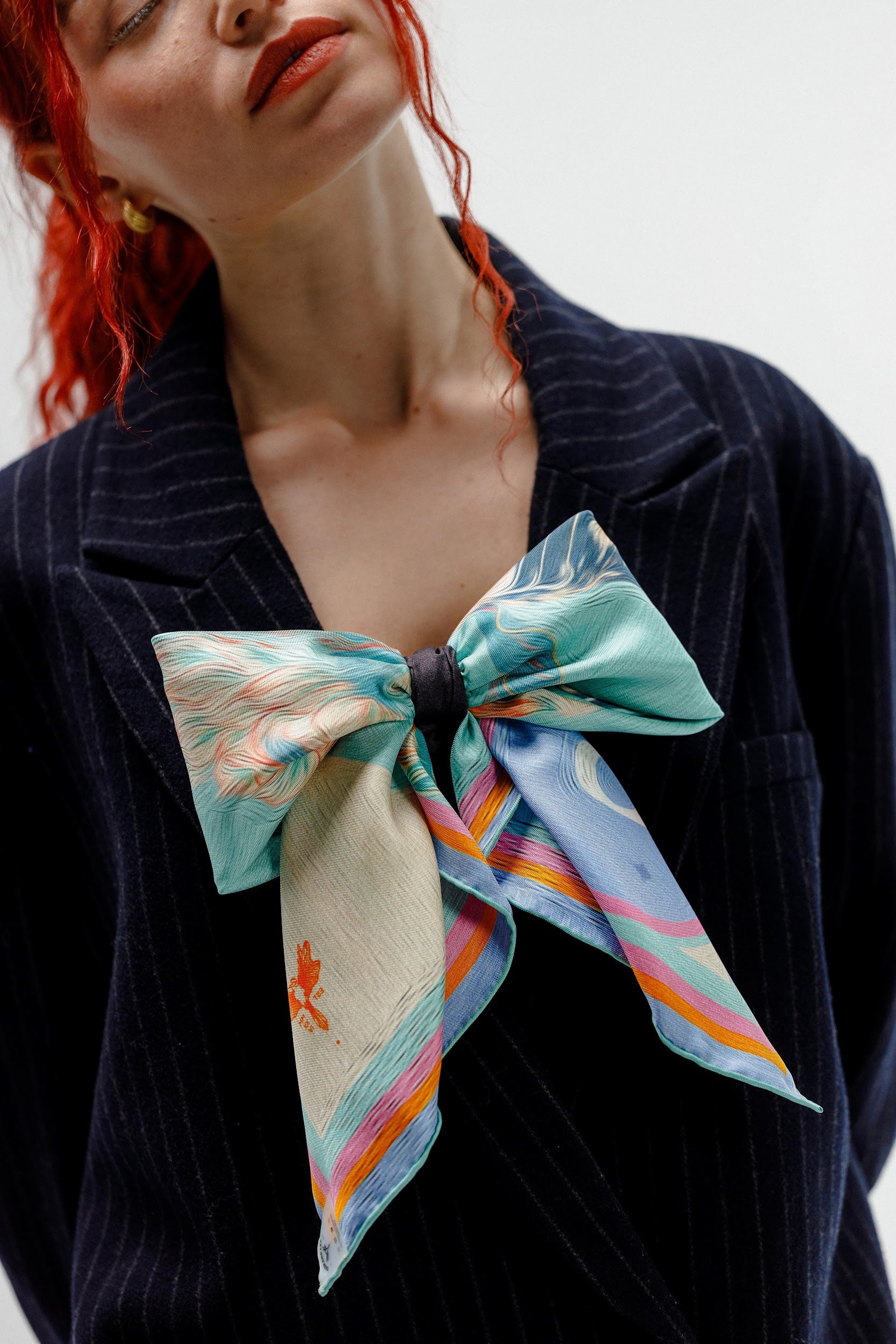 Model wearing silk twill square scarf as a bow
