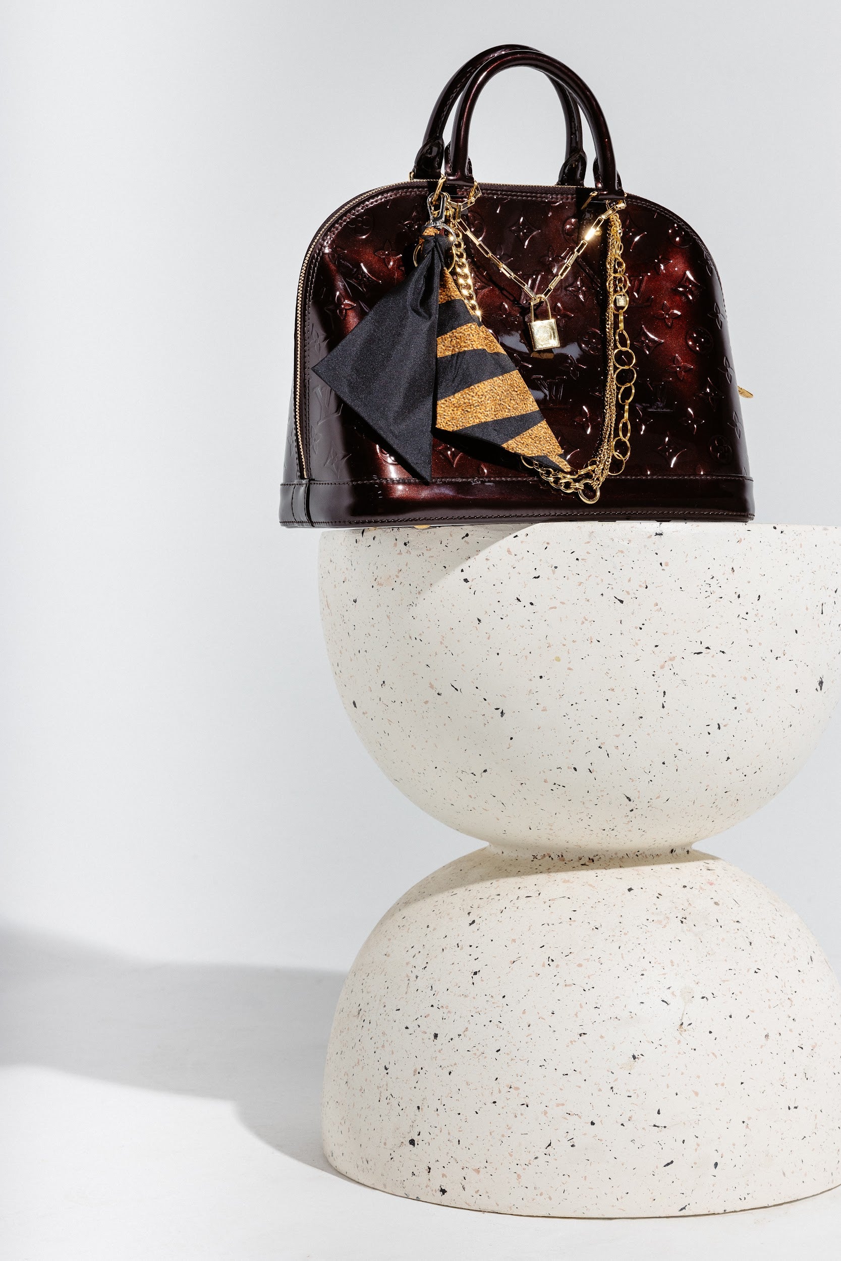 100% silk black and gold bag charm hooked on bag