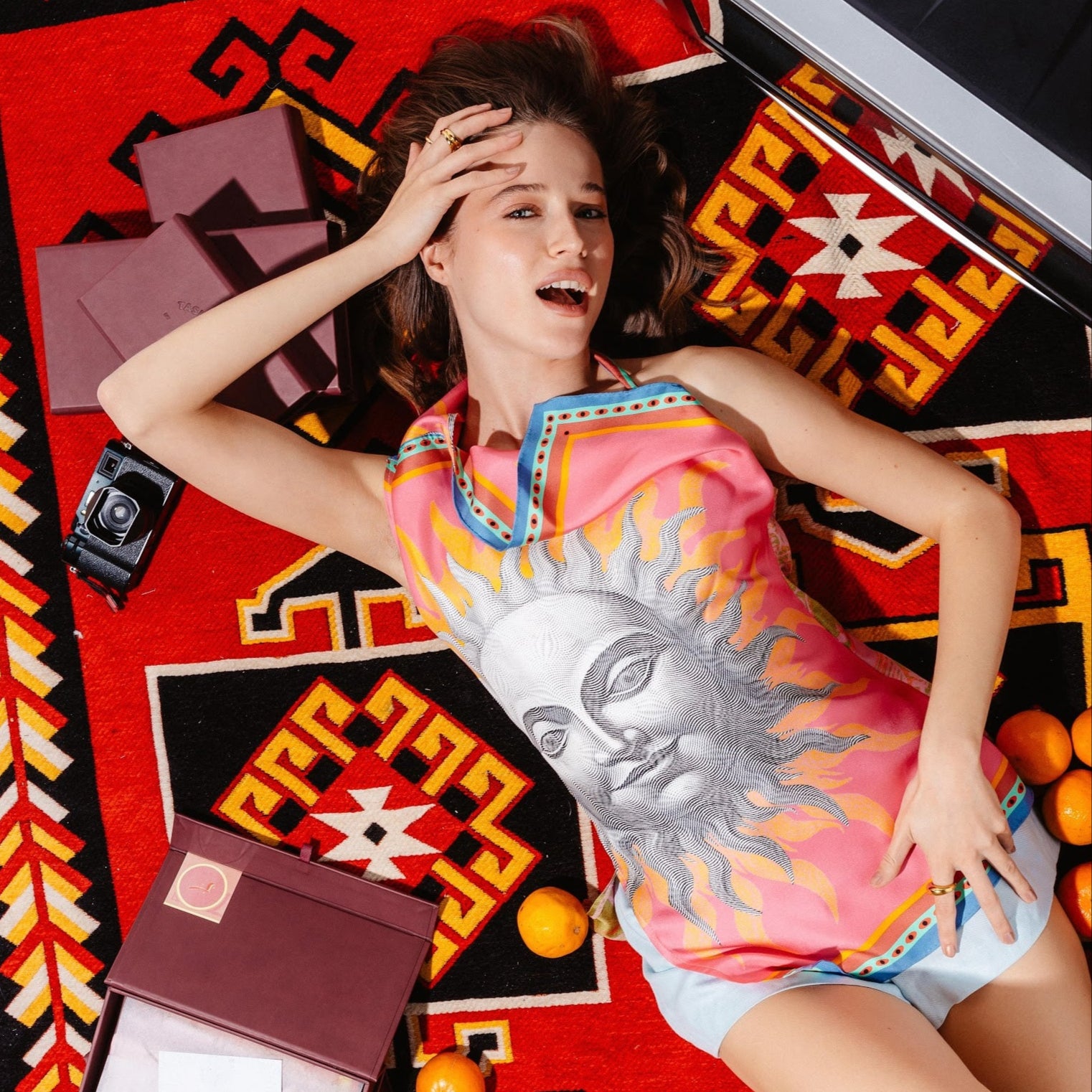 Model wearing Asymmetrical top with crochet details made from silk with sun design in front