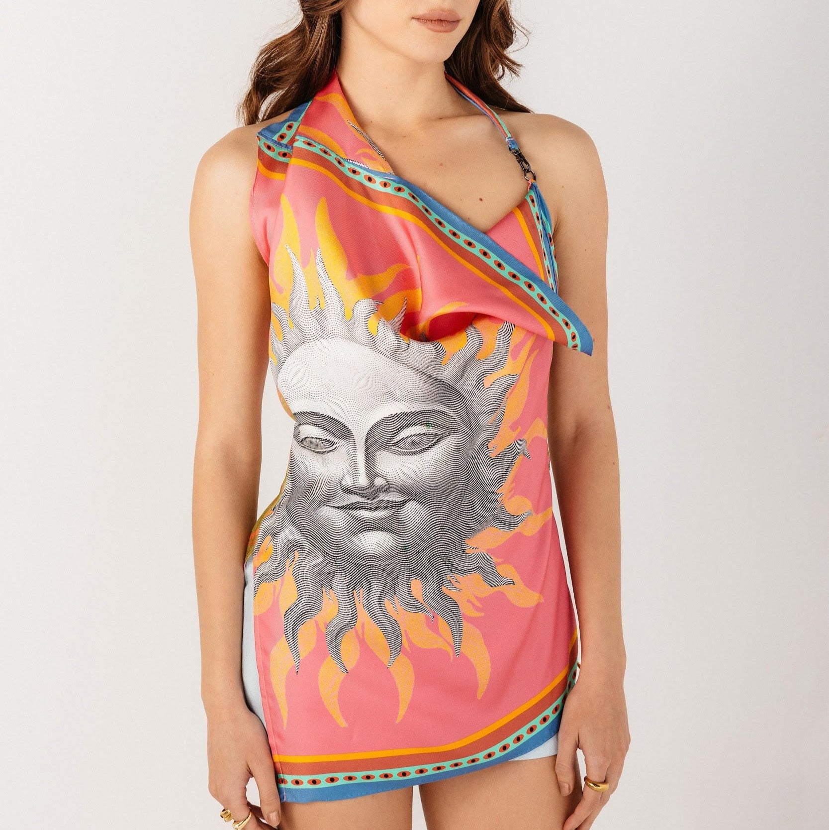 Asymmetrical top with crochet details made from silk with sun design in front