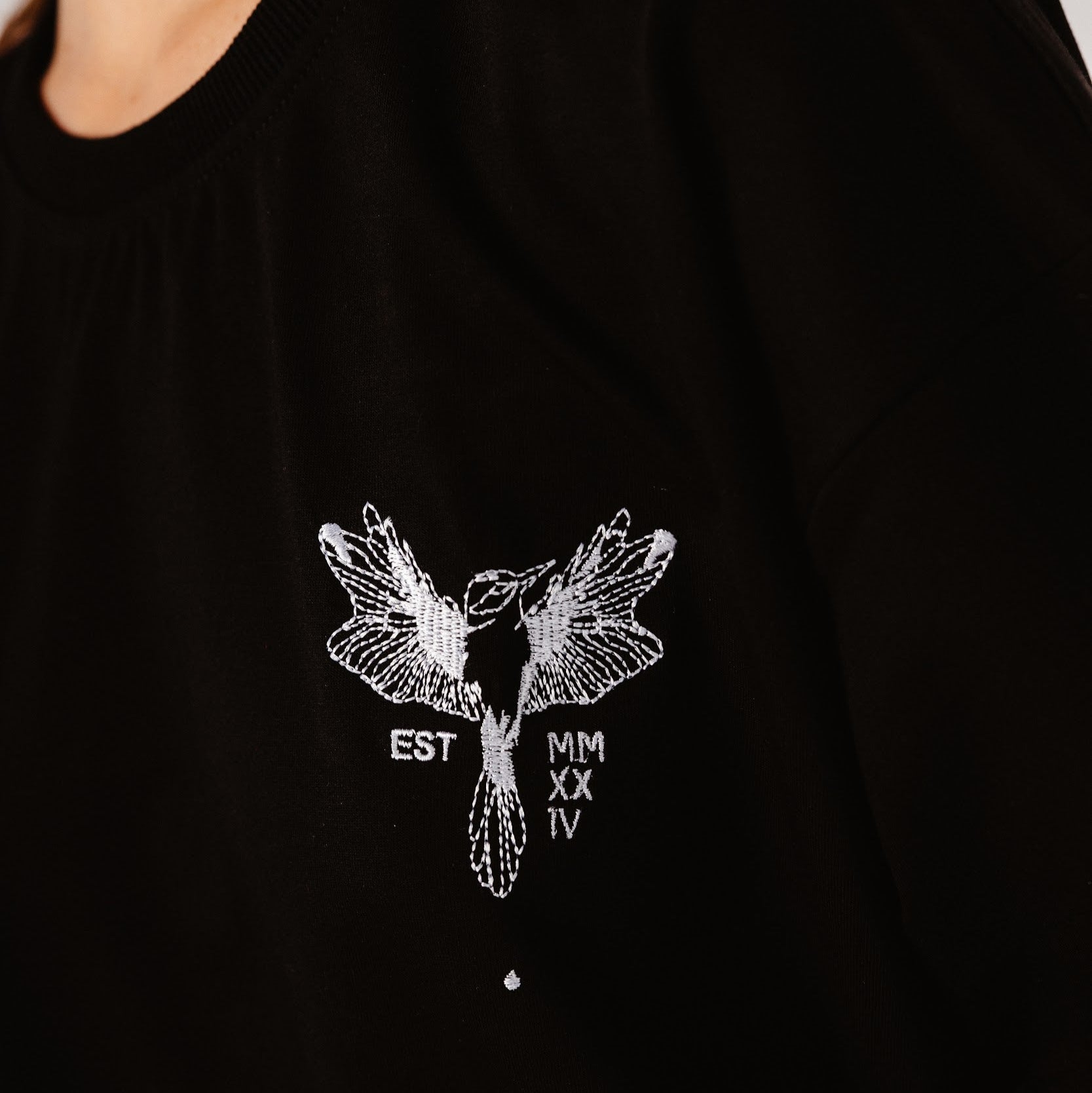 Details of Black top with white hummingbird embroidered