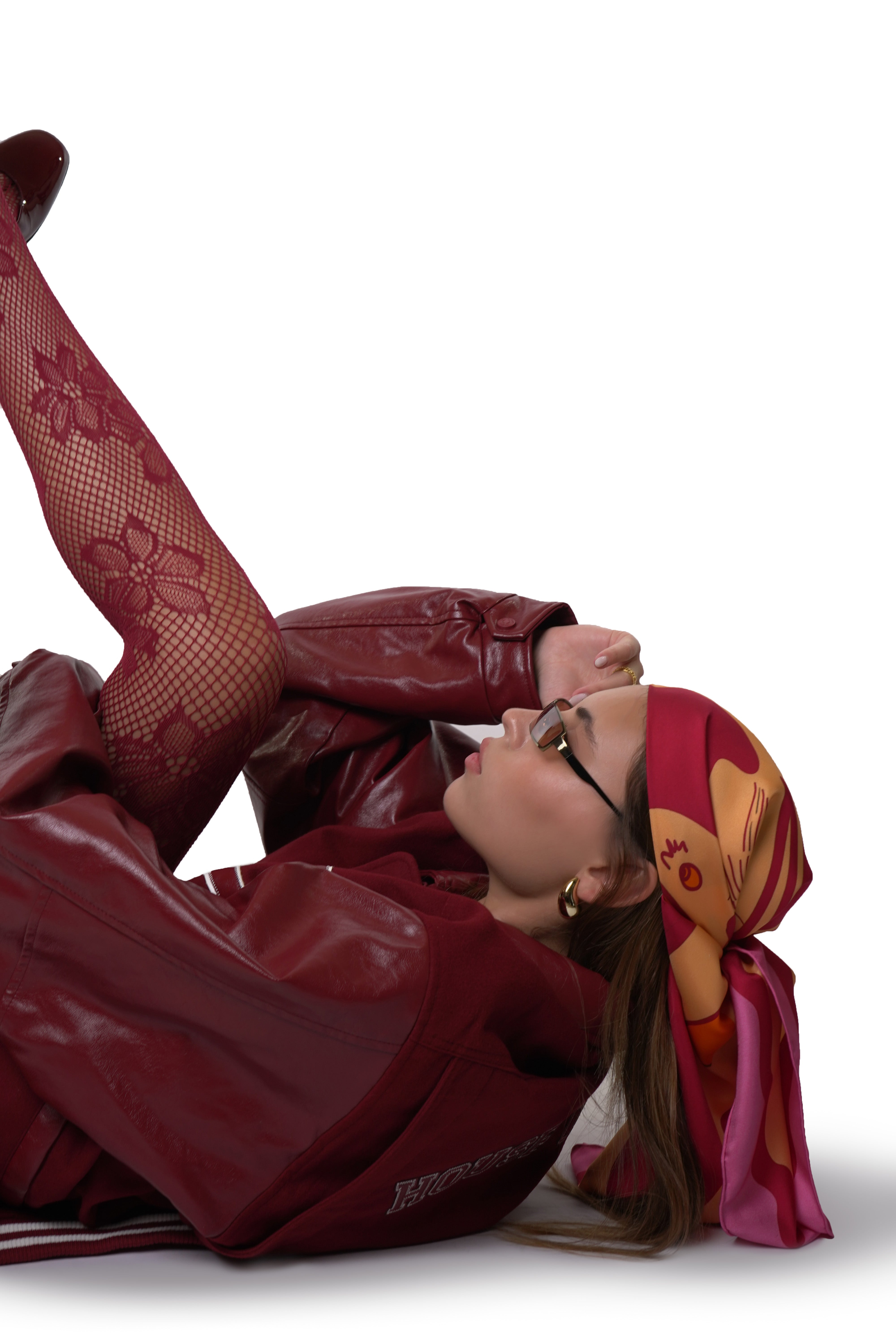 Model wearing pink and orange silk twill square scarf as bandana on head