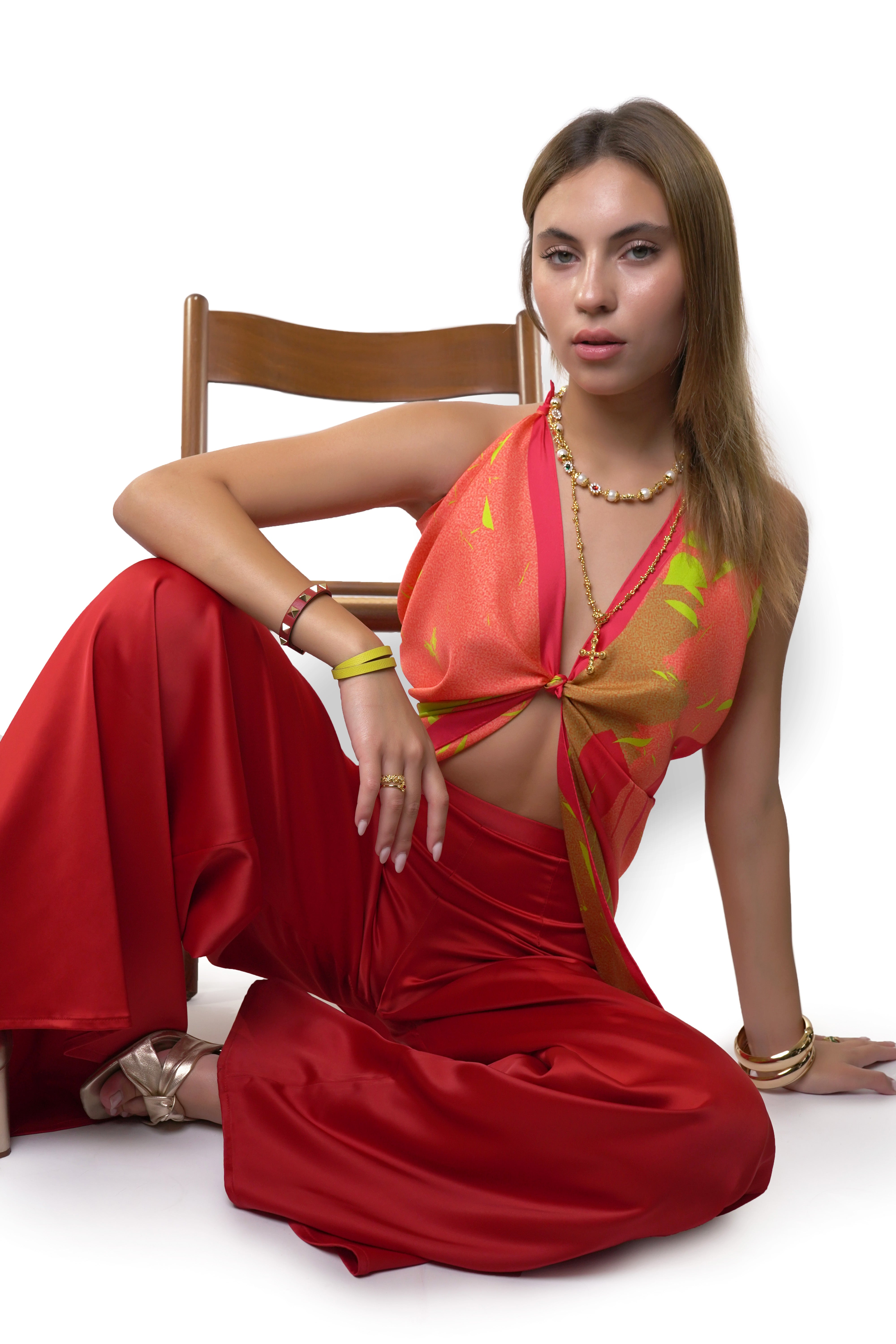 Model wearing silk twill square scarf in red pink yellow print