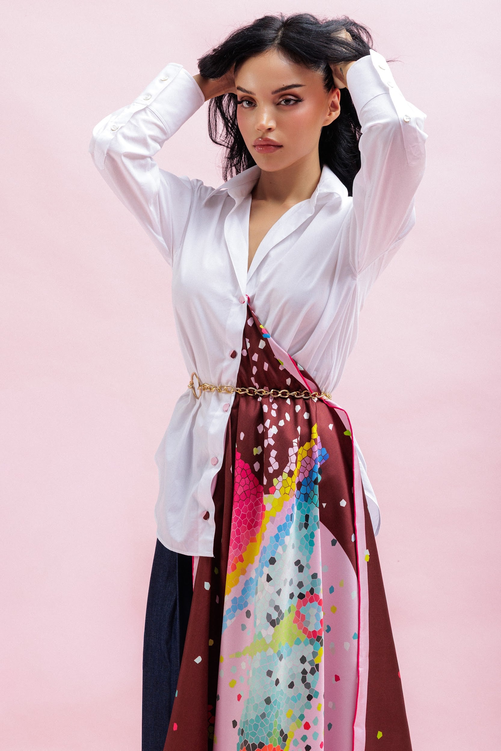 Model wearing a white blouse with a colorful silk scarf