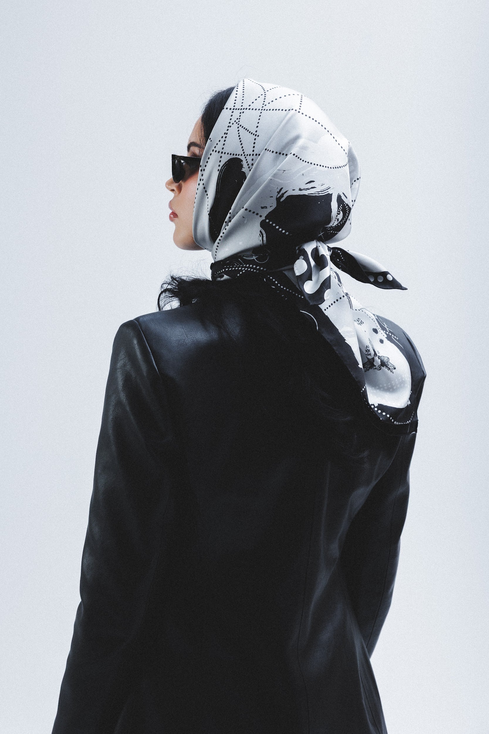 Model wearing a silk square scarf on the head designed by artist