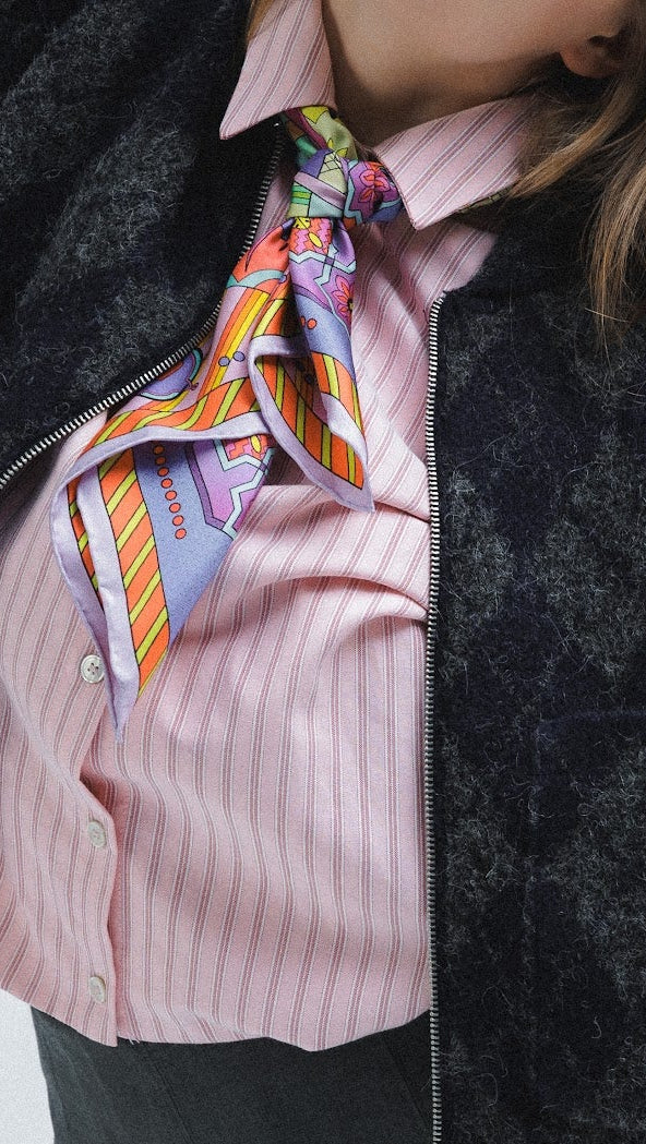 Model wearing silk scarf around her neck as a tie