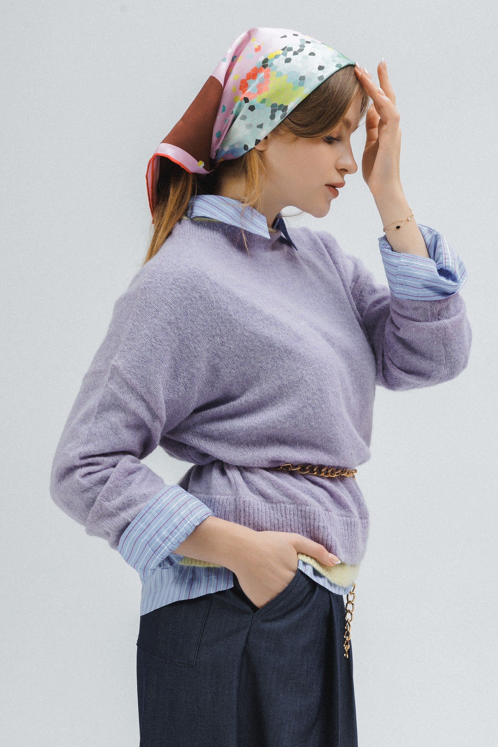 Model wearing a colorful silk scarf with abstract design as a bandana on her hair