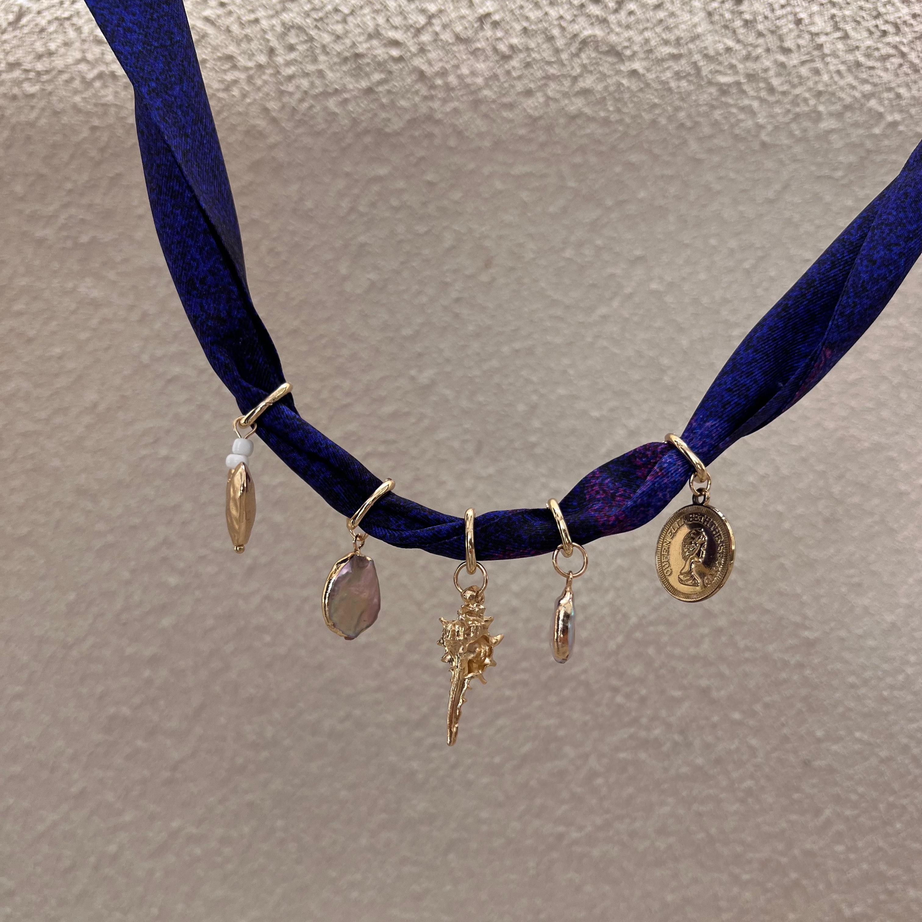 gold charm necklace made with silk fabric