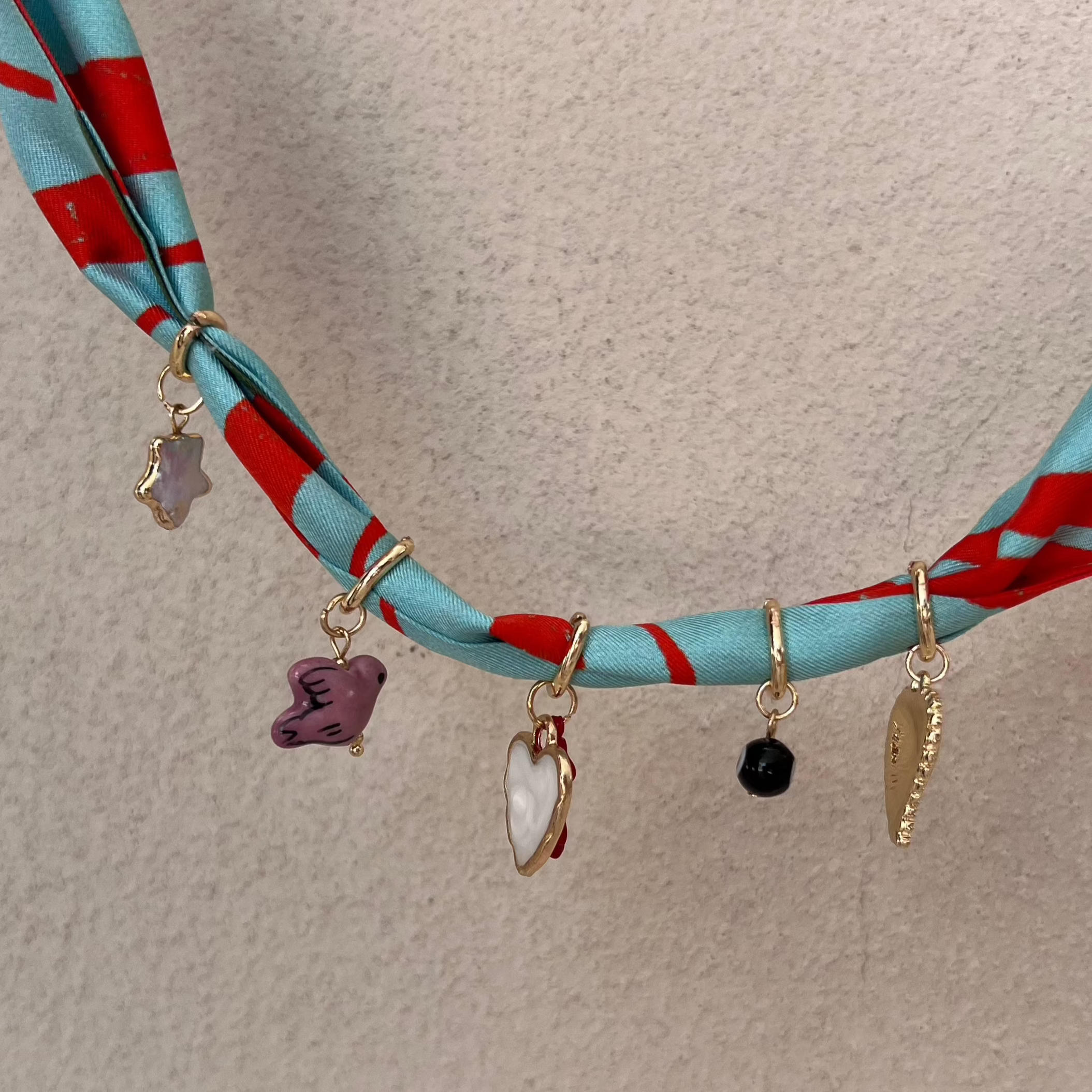 charm necklace made from silk fabric