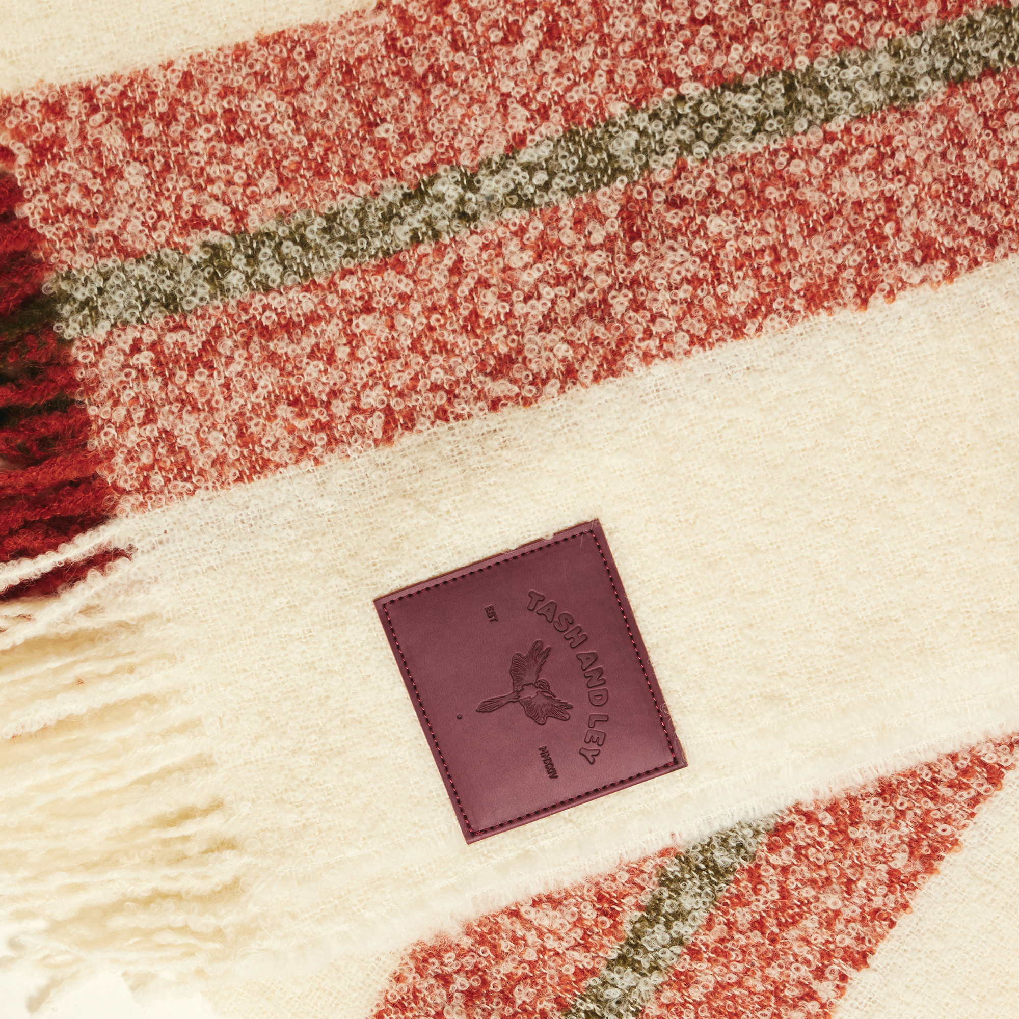 White with red and green stripes alpaca wool scarf with TASH AND LEY brand label on the side