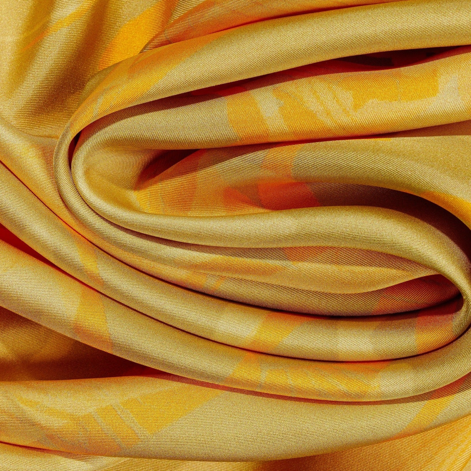 zoom on silk twill fabric with orange and beige print