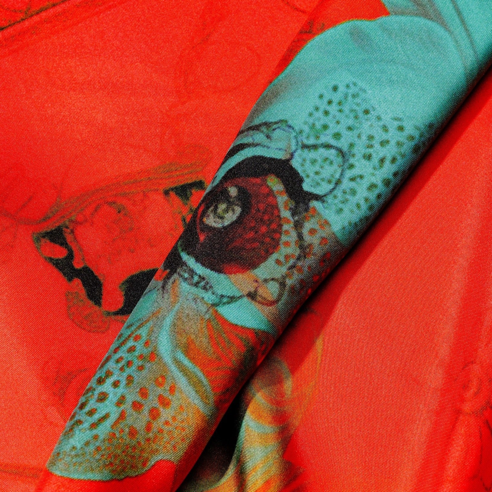 zoom on silk twill fabric with orange and blue eye print