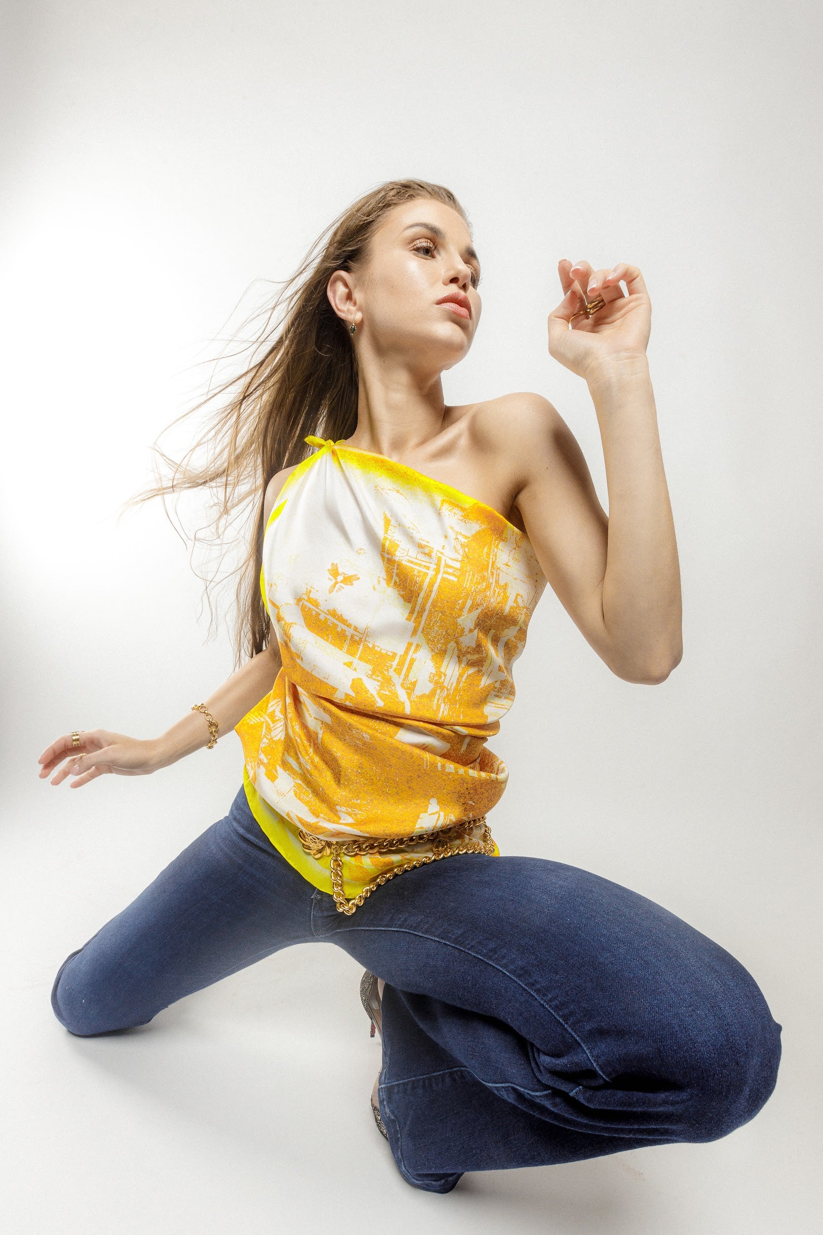 Model wearing silk twill square scarf with yellow and white print as a top