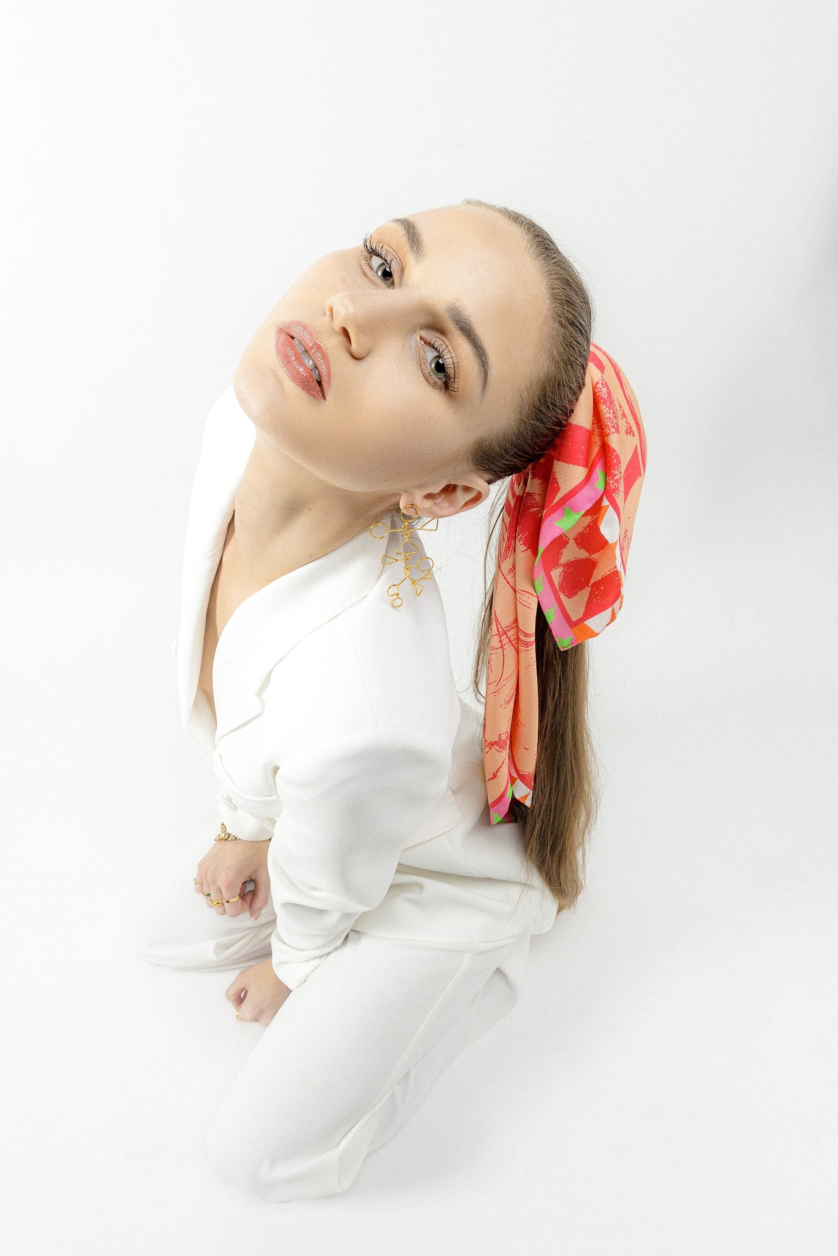 Model wearing silk square scarf on her ponytail