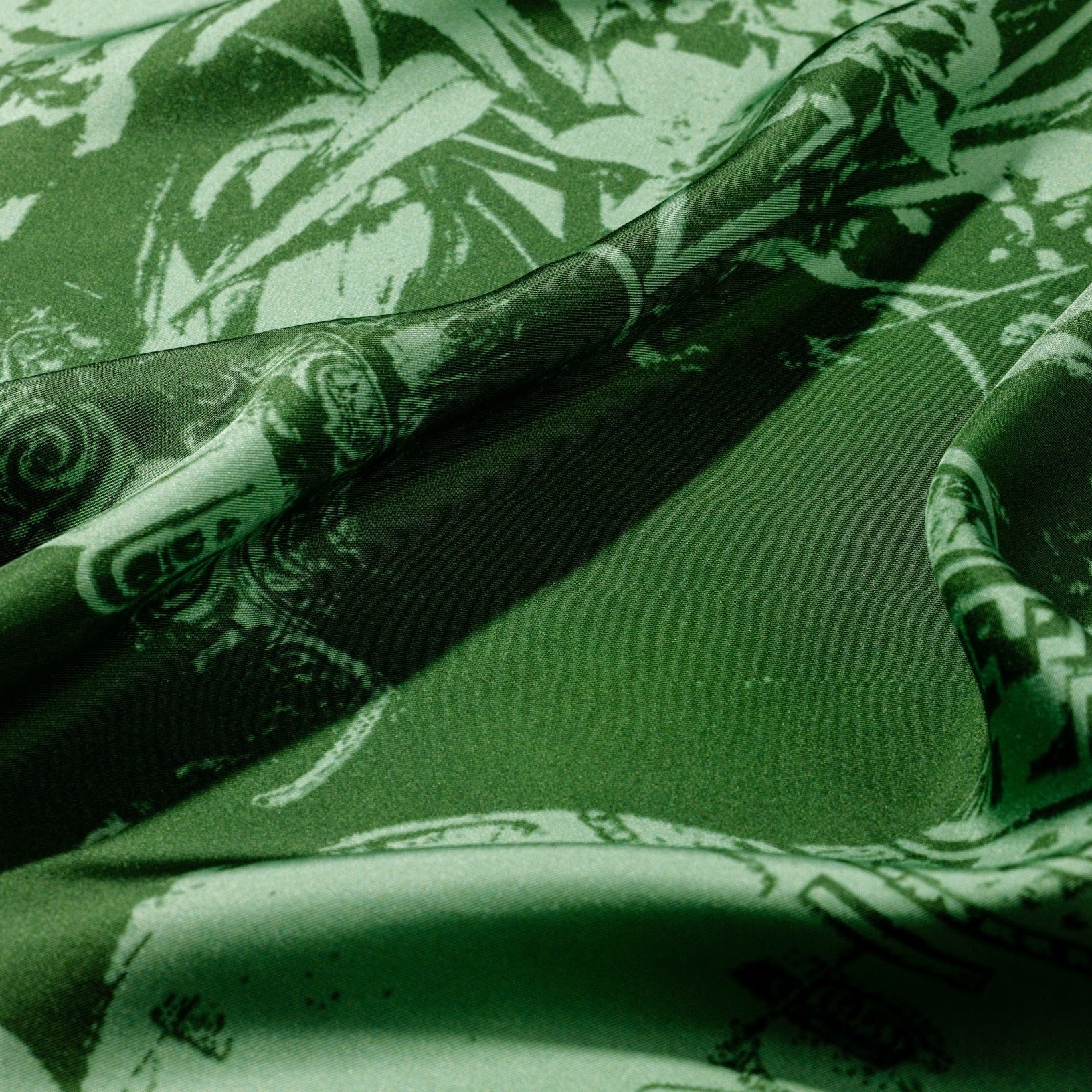 zoom on silk twill fabric with green print