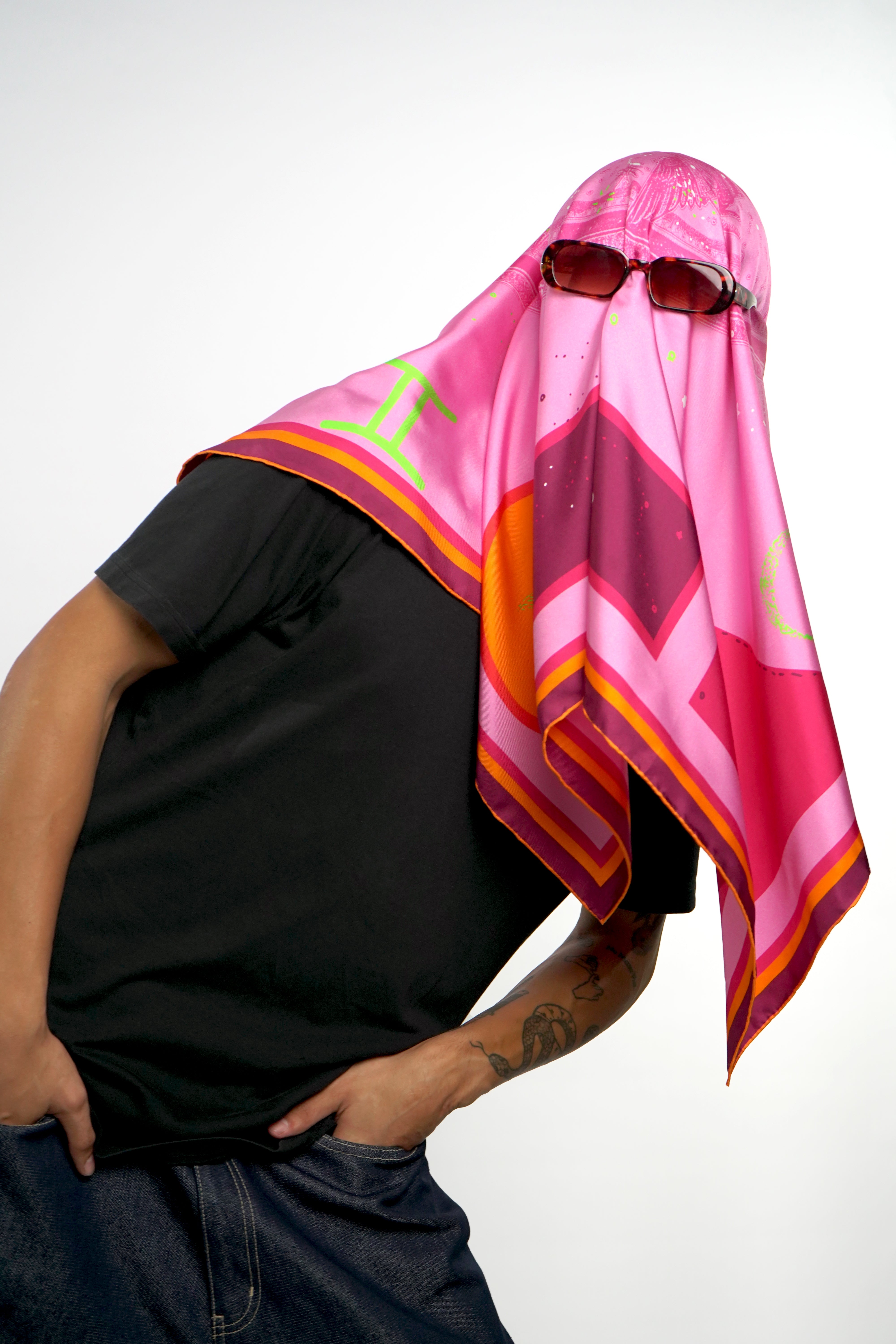 Model covering head with silk twill square scarf