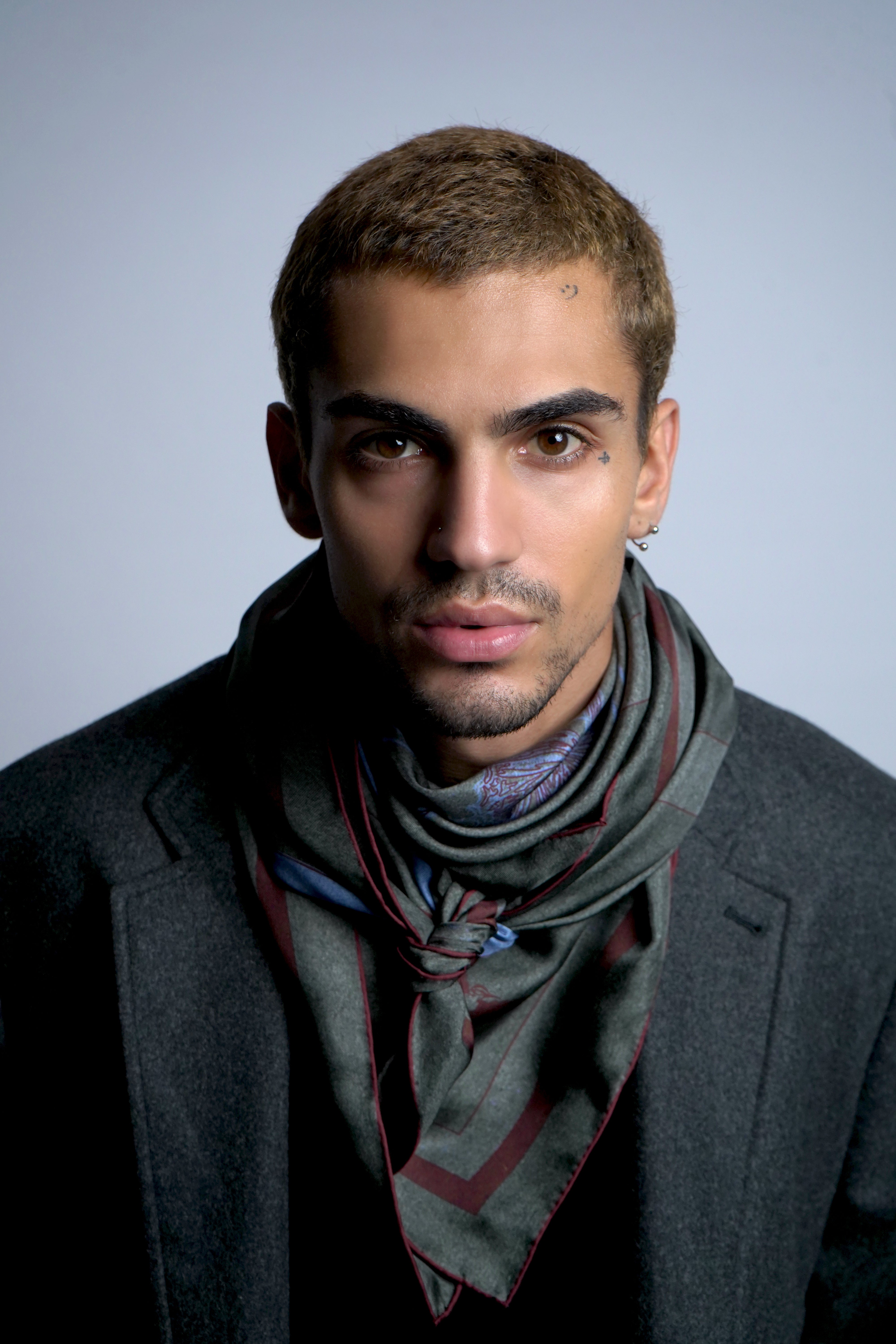 Male model wearing silk twill square scarf around neck