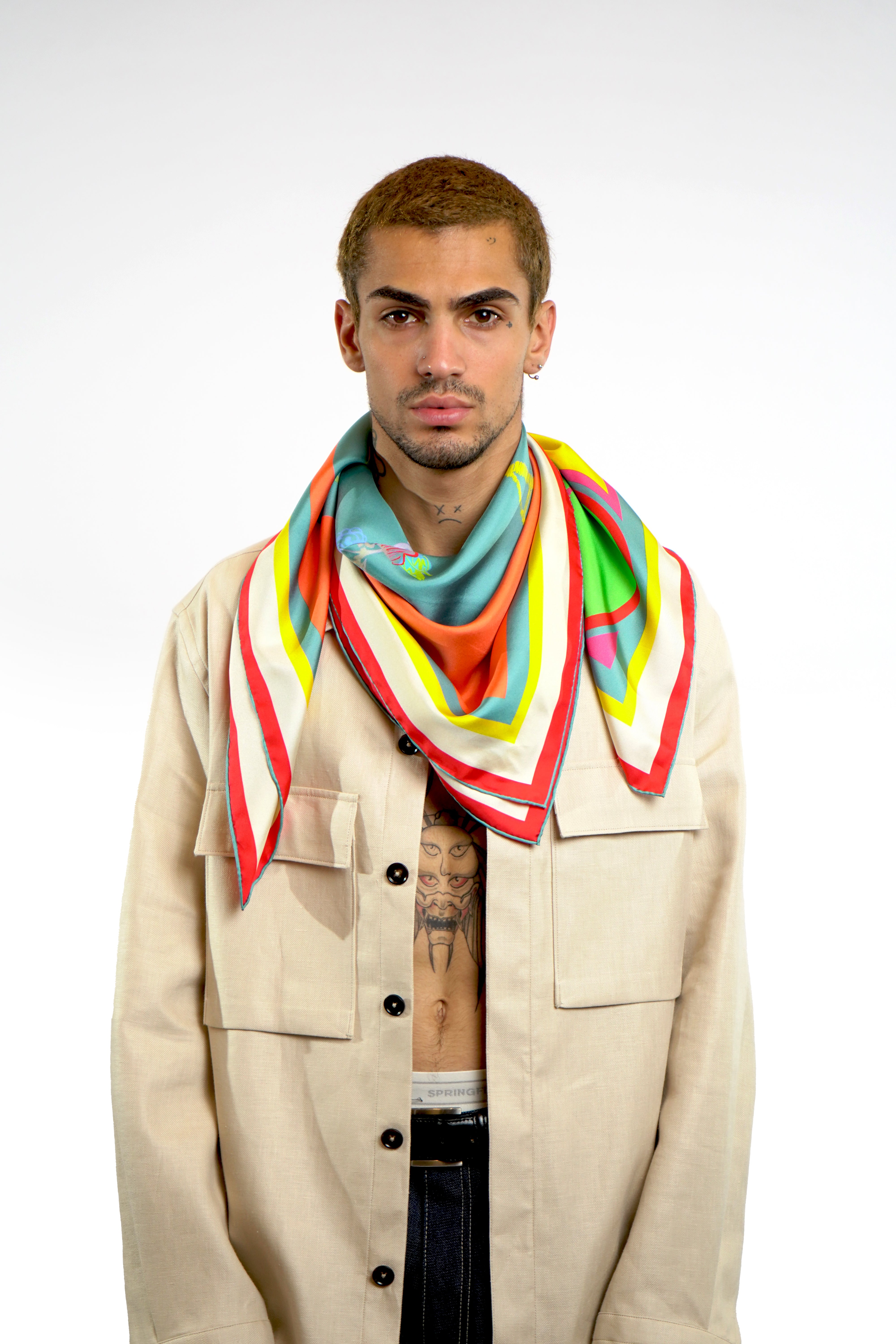 Male model wearing silk twill square scarf around neck