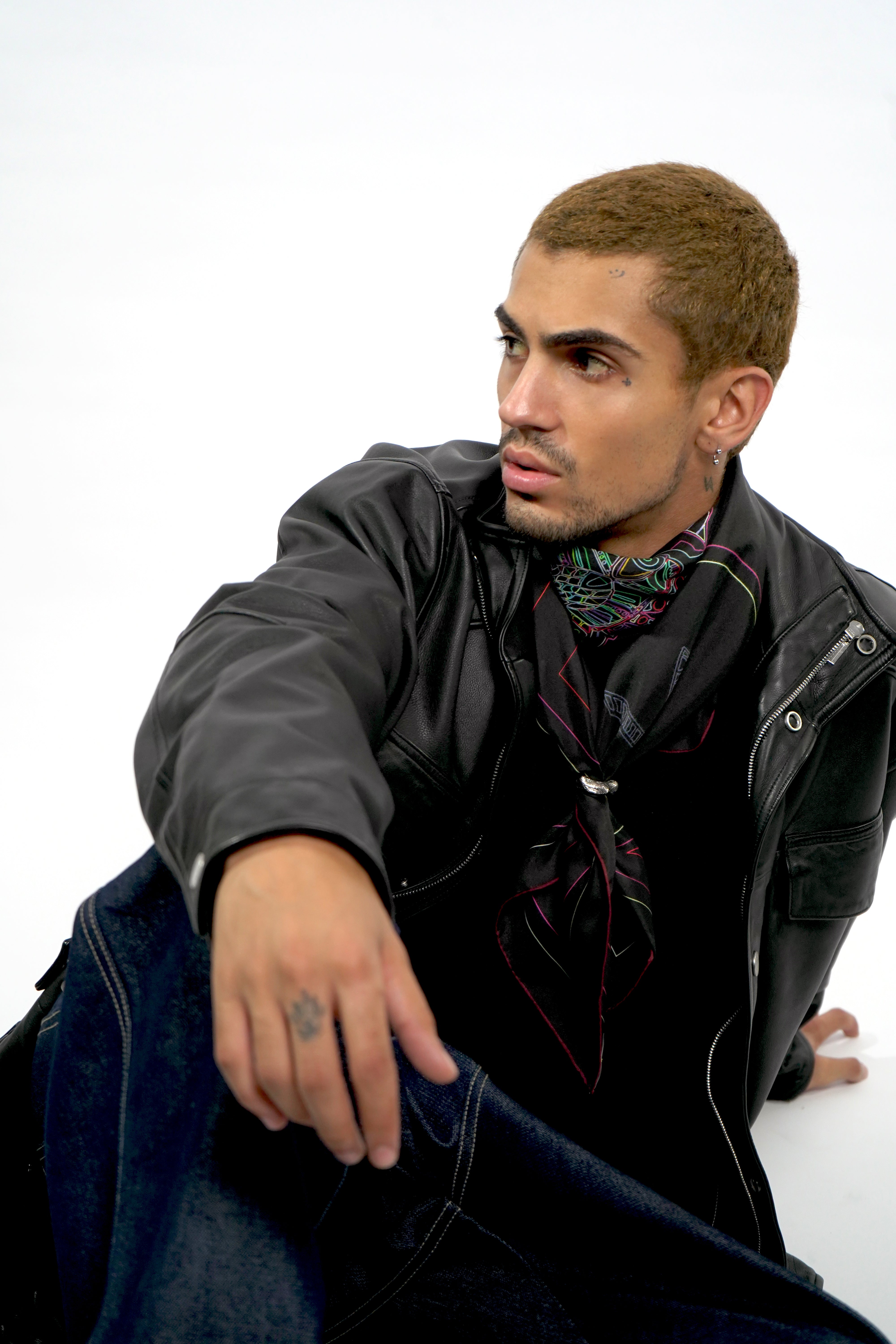 Male model wearing black silk twill square scarf around neck
