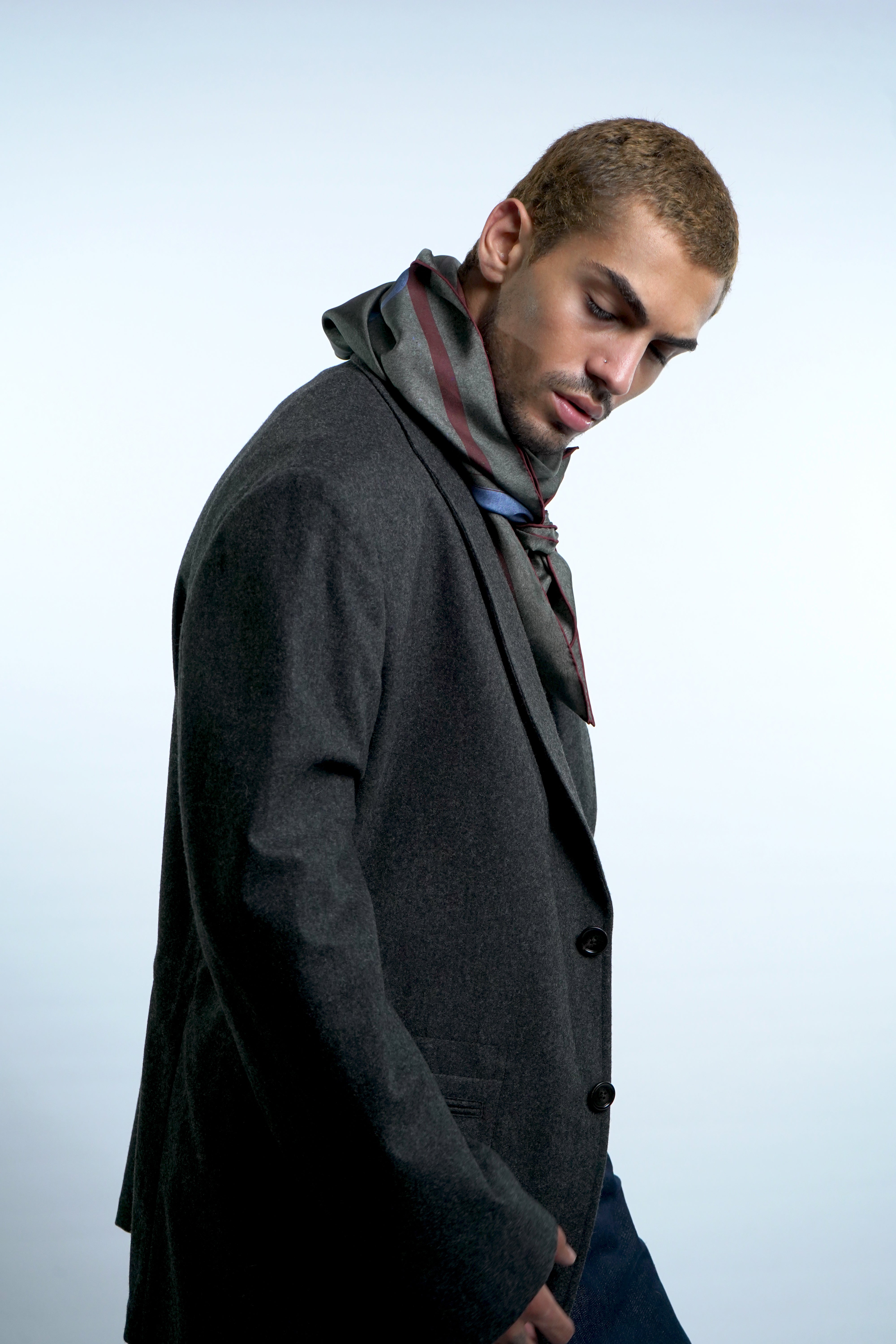 Male model wearing grey silk twill square scarf around neck