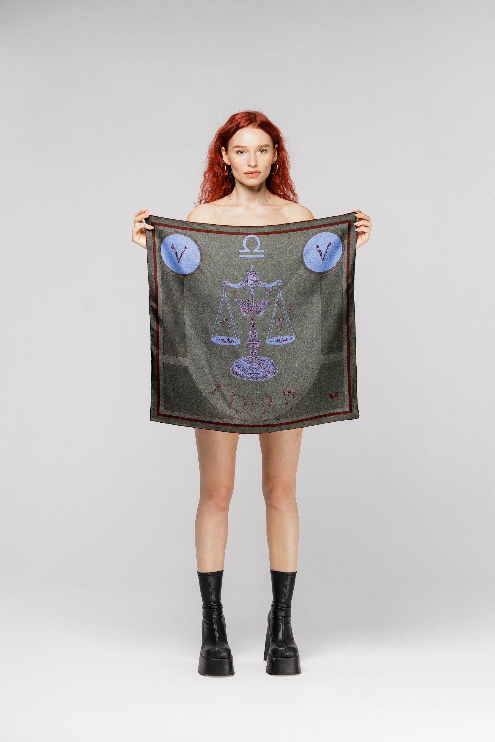 Model holding silk twill square scarf with Libra astrology design