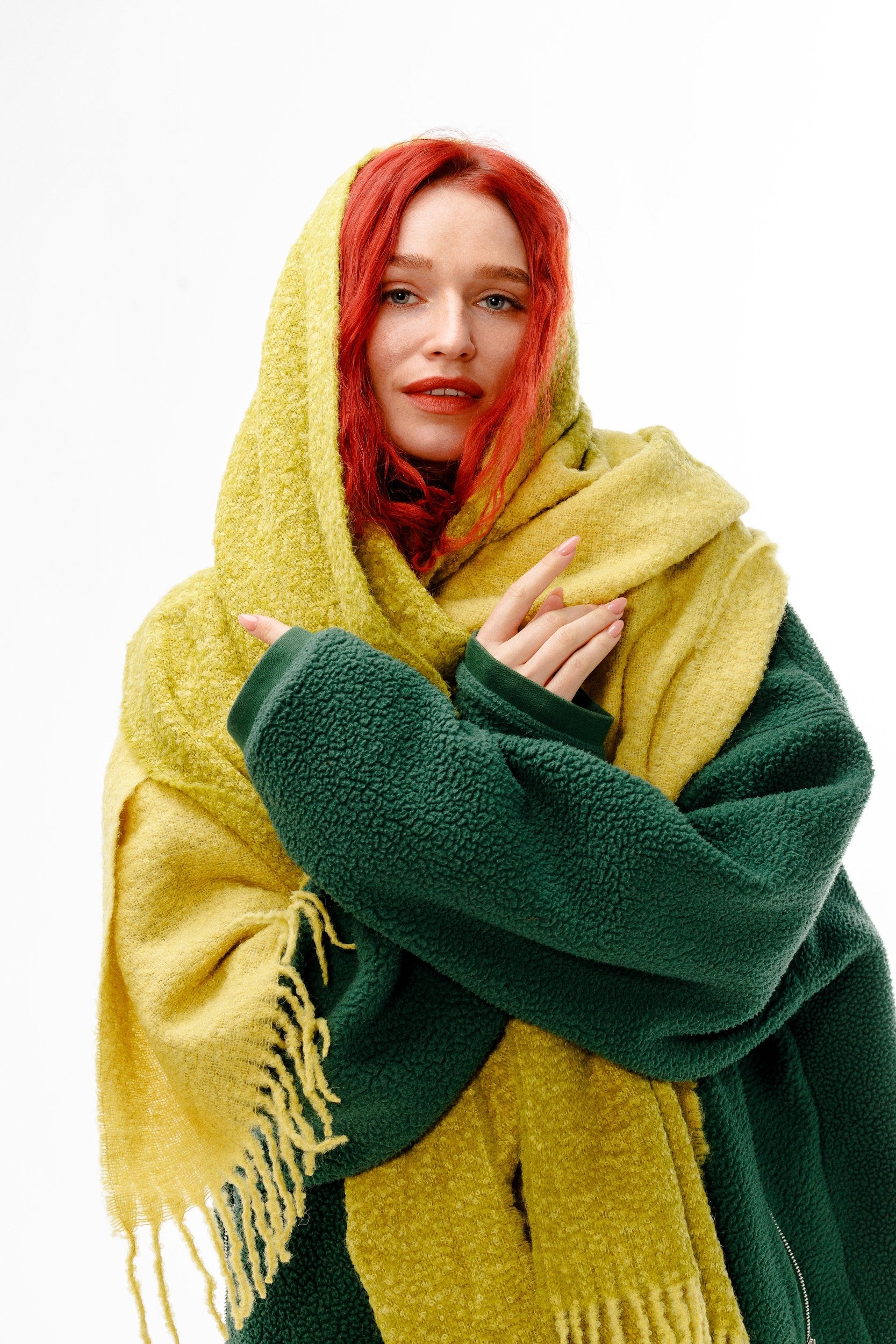 Model wrapped in winter alpaca wool scarf in green and yellow colors