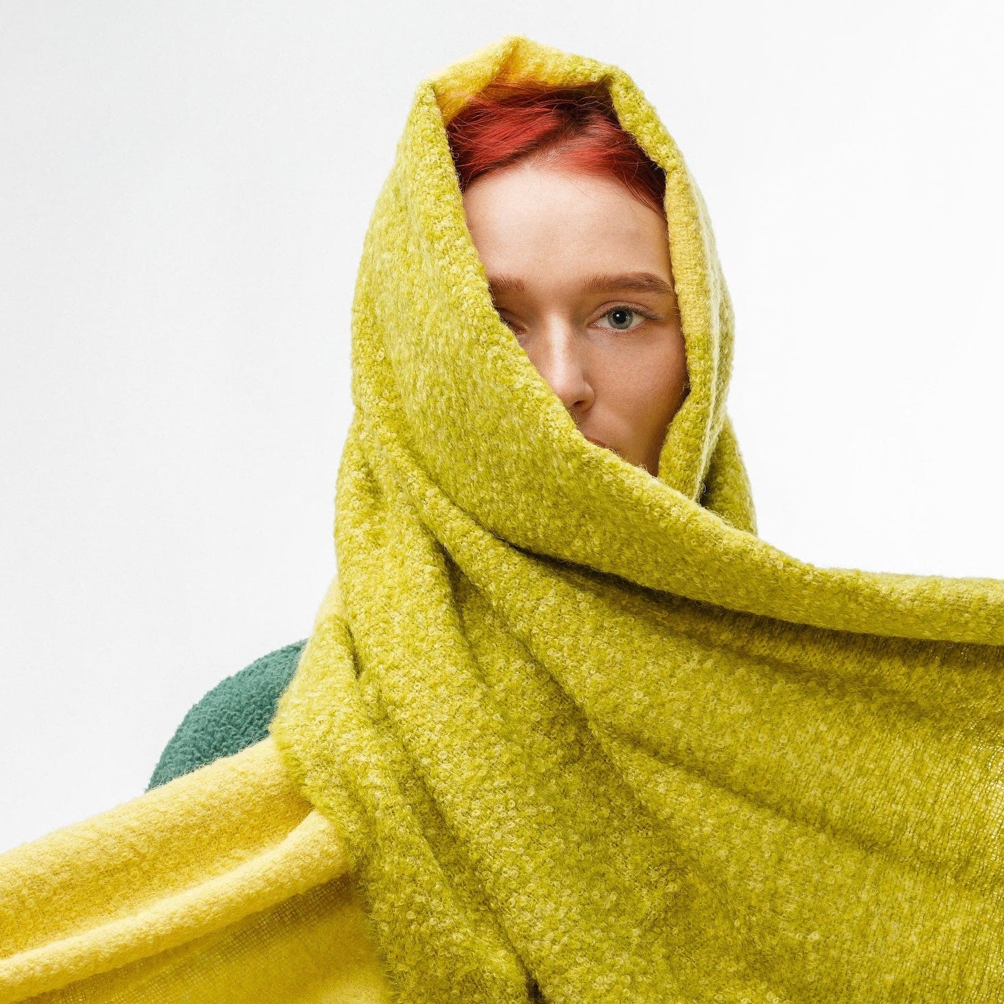 Model wearing alpaca wool winter scarf in green and yellow