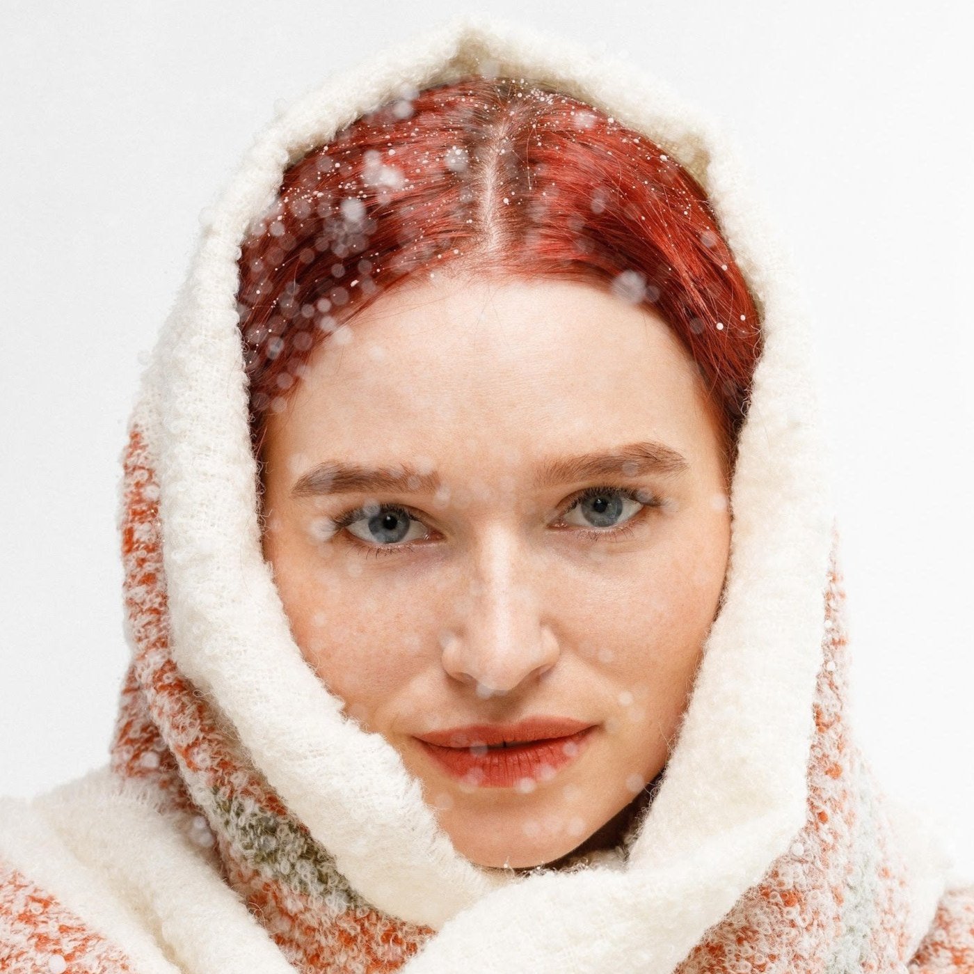 Model wearing white alpaca wool winter scarf with snow effect