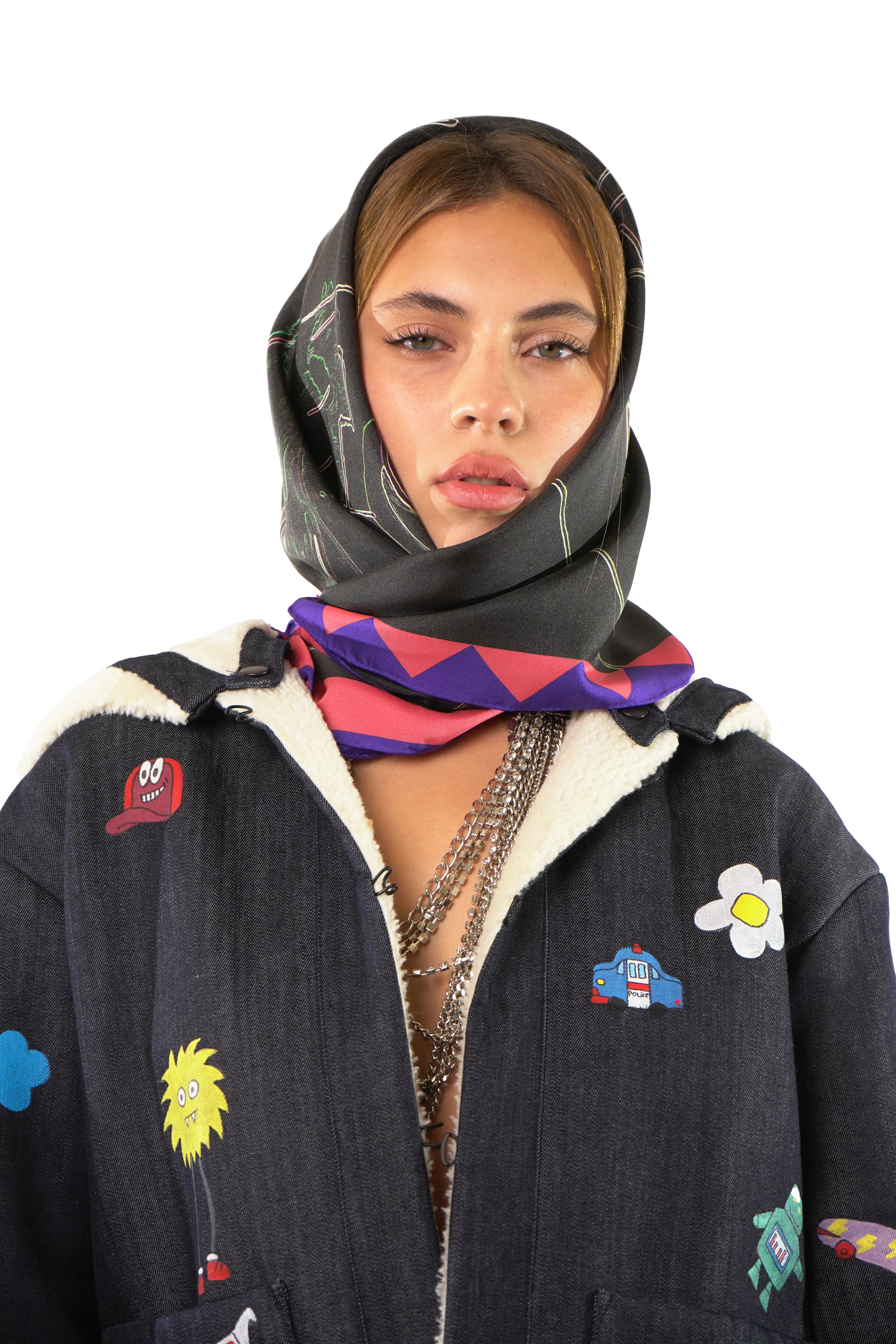 Model wearing silk twill square scarf with black blue and pink print as a head scarf