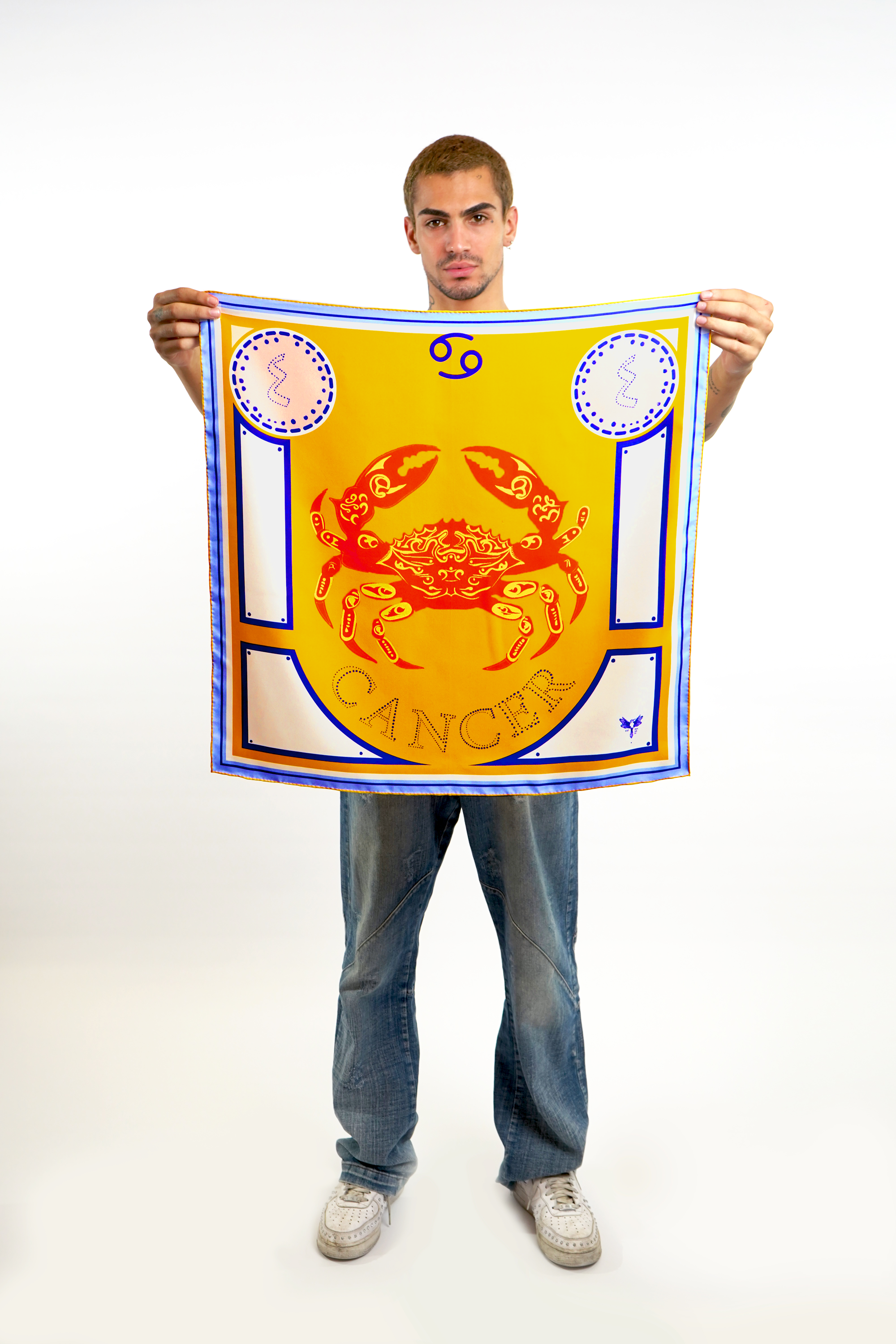 Male model holding silk twill square scarf with Cancer design