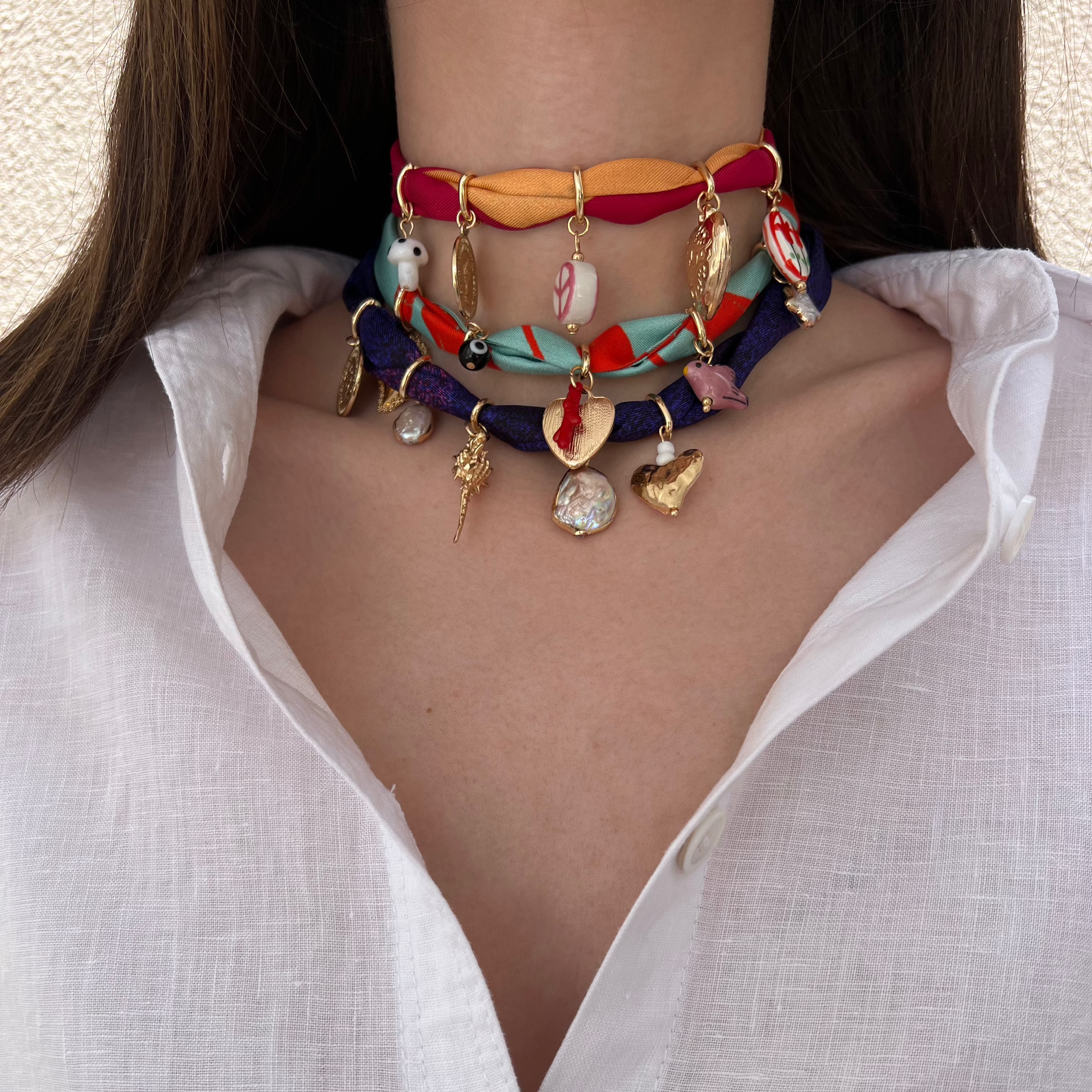 charm necklaces made from silk fabric in different colors and different charms