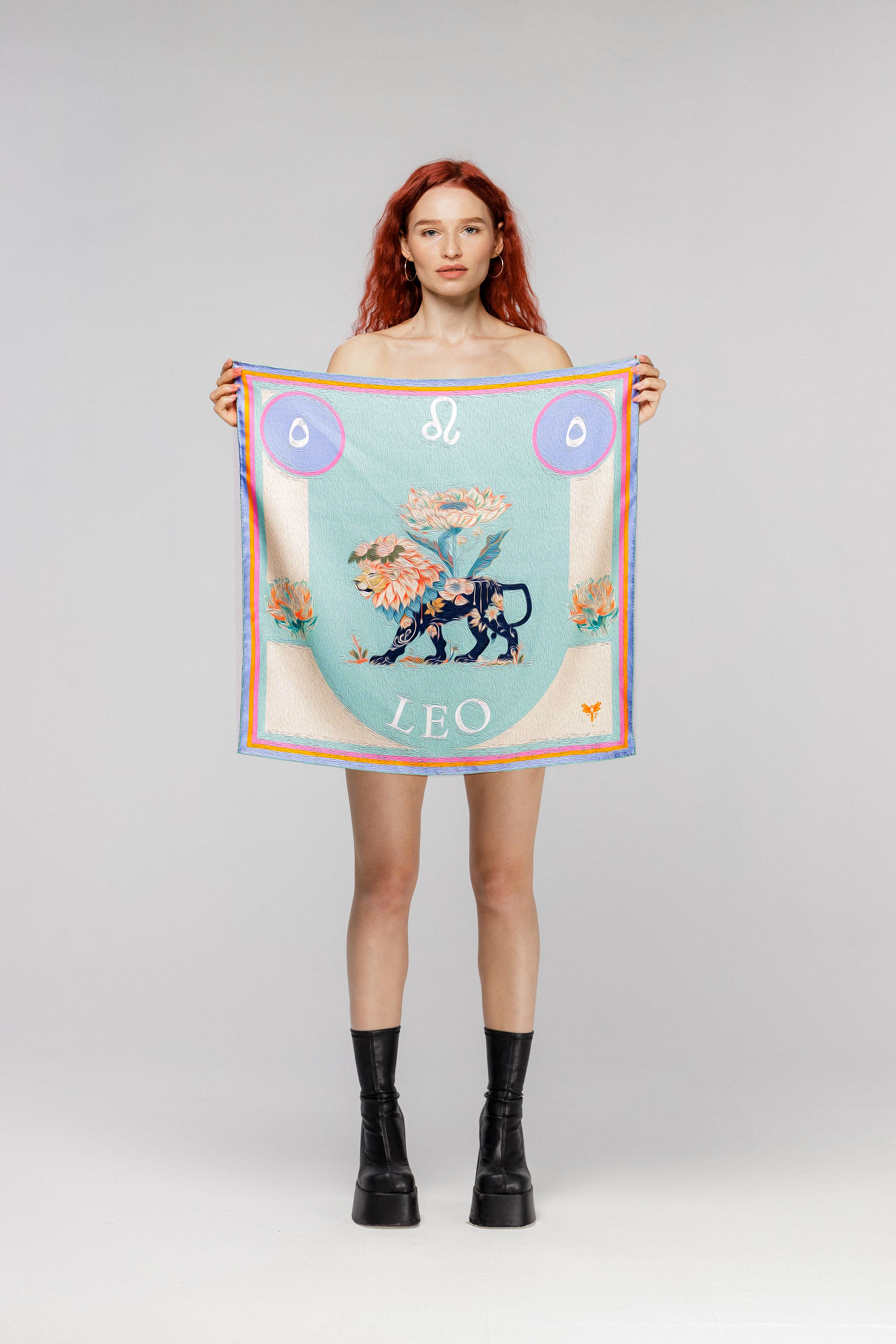 Model holding silk twill square scarf with Leo astrology design