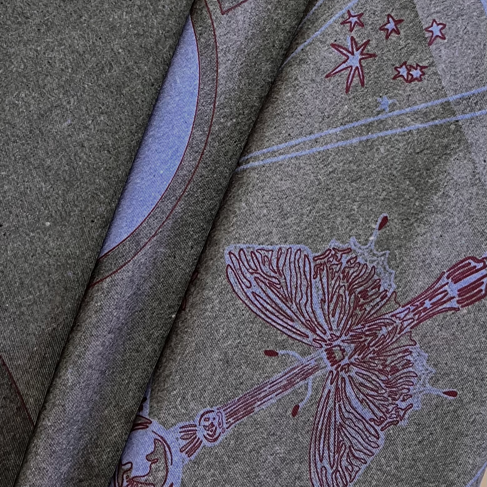 zoom on silk twill fabric with grey print and butterfly drawing