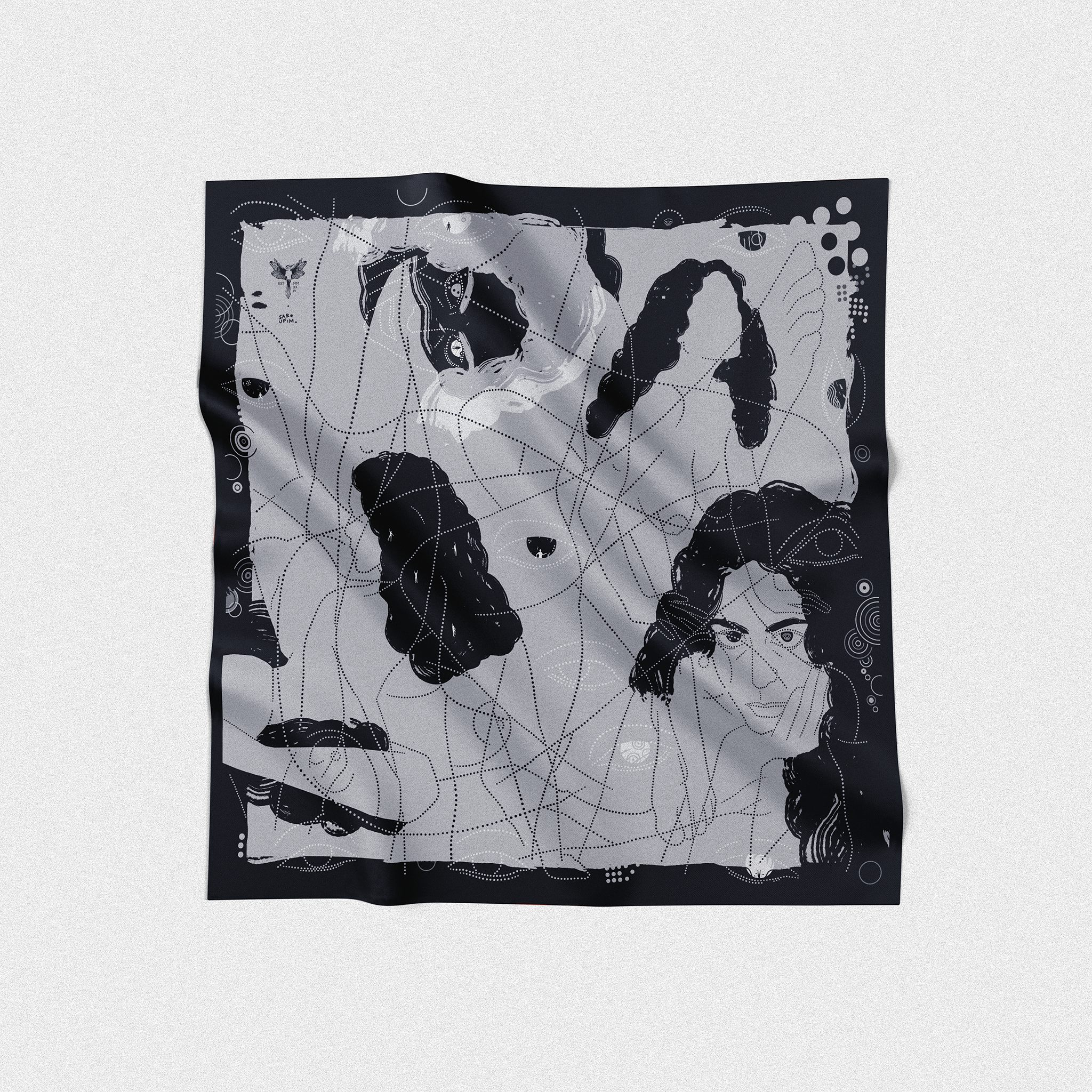 Black and white scarf with abstract designs on a light gray background