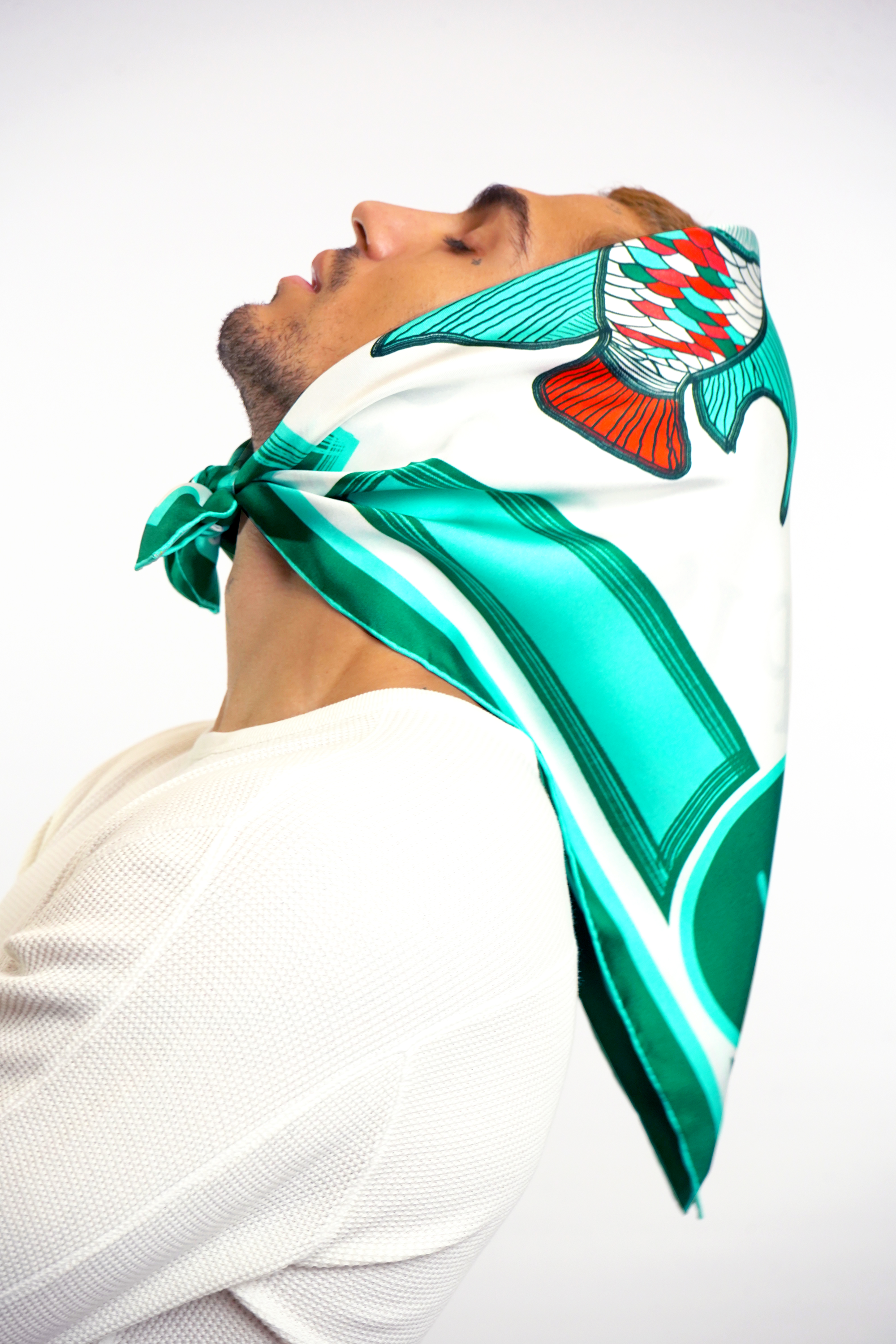 Male model wearing pisces design silk twill square scarf around head