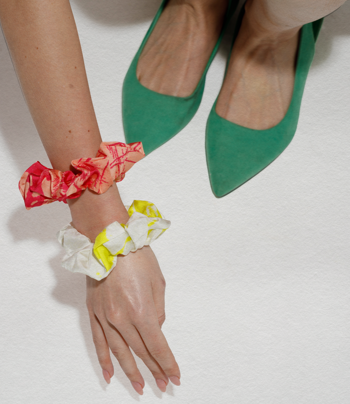 Model hand with silk twill scrunchies colorful on hand