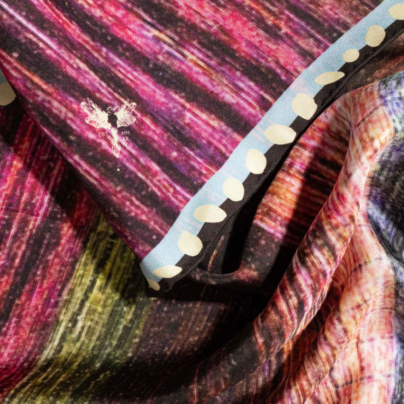 Details of square silk scarf with a multicolor pattern