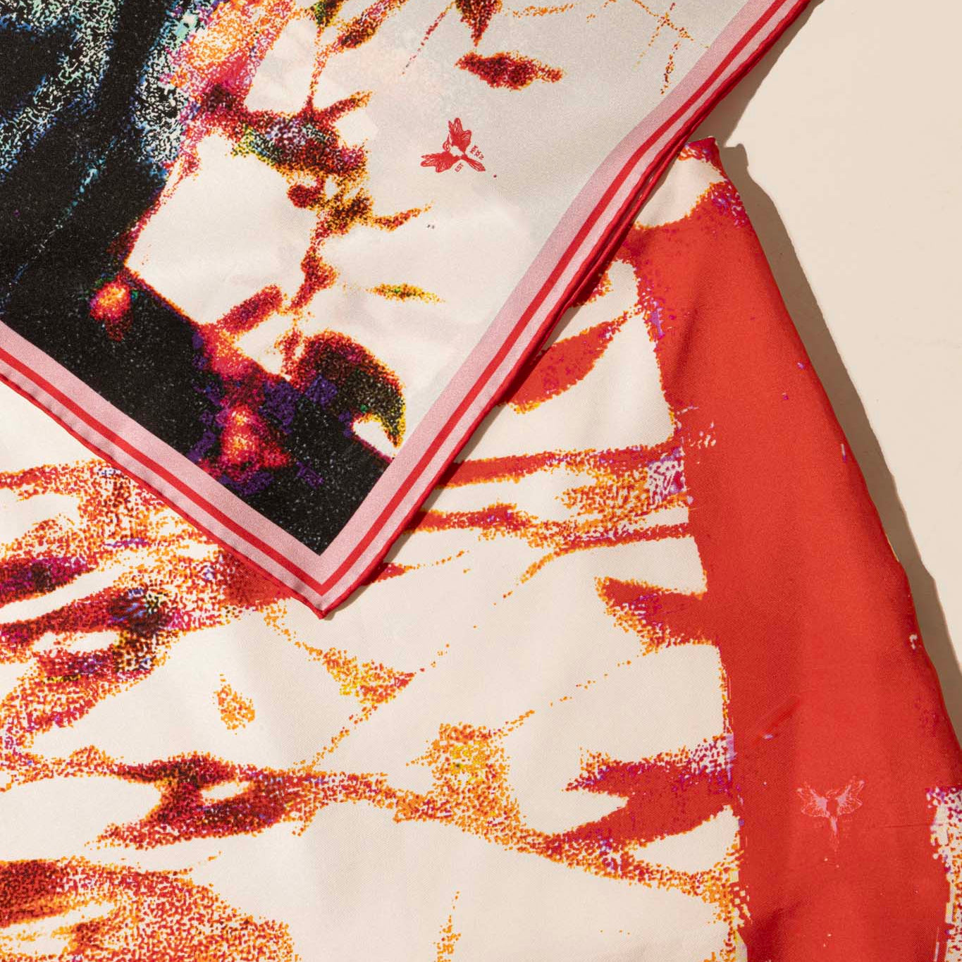 Close-up of a colorful silk skirt with abstract patterns and matching silk scarf