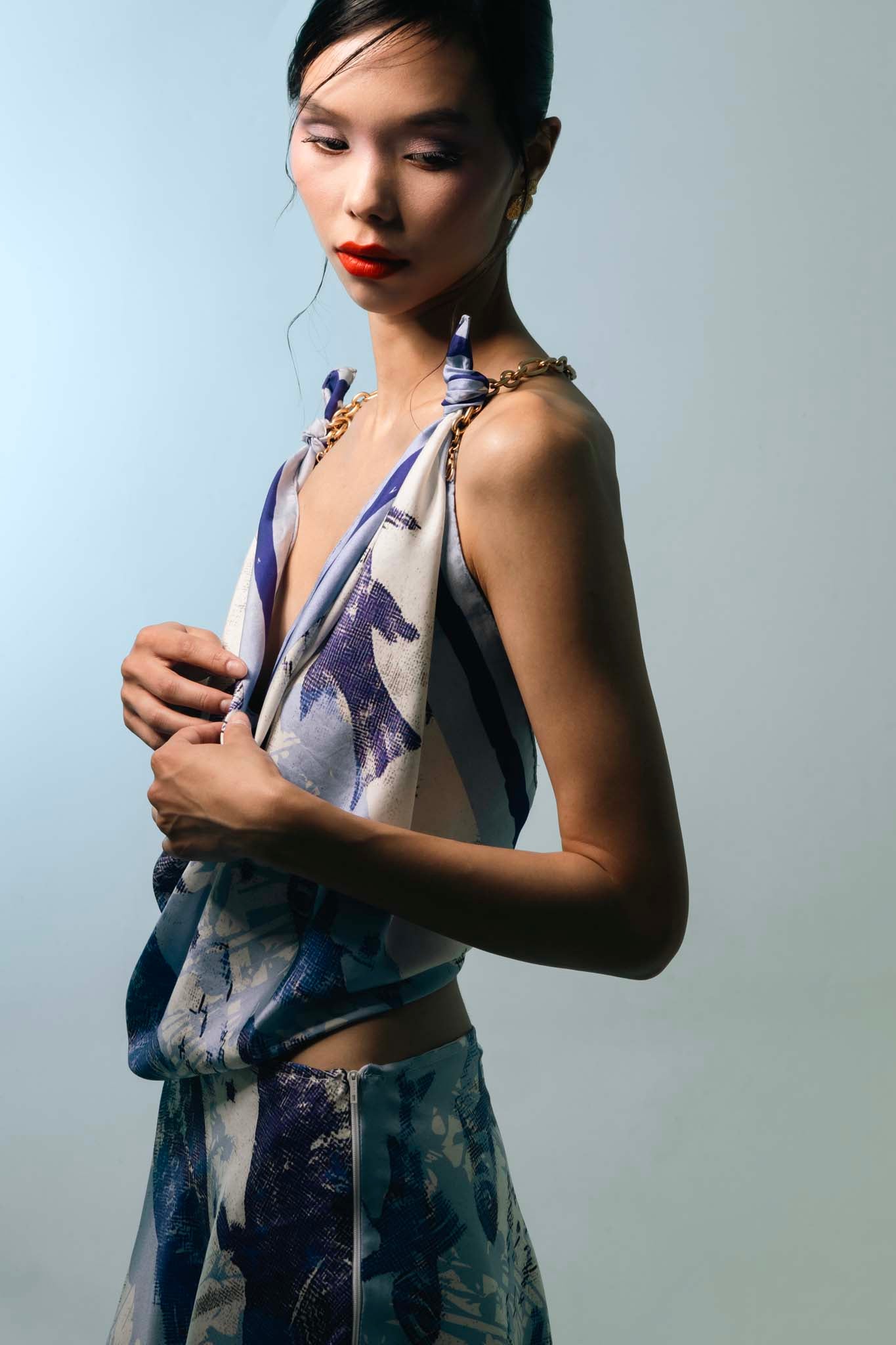 Woman wearing a set with a silk scarf as top and matching skirt