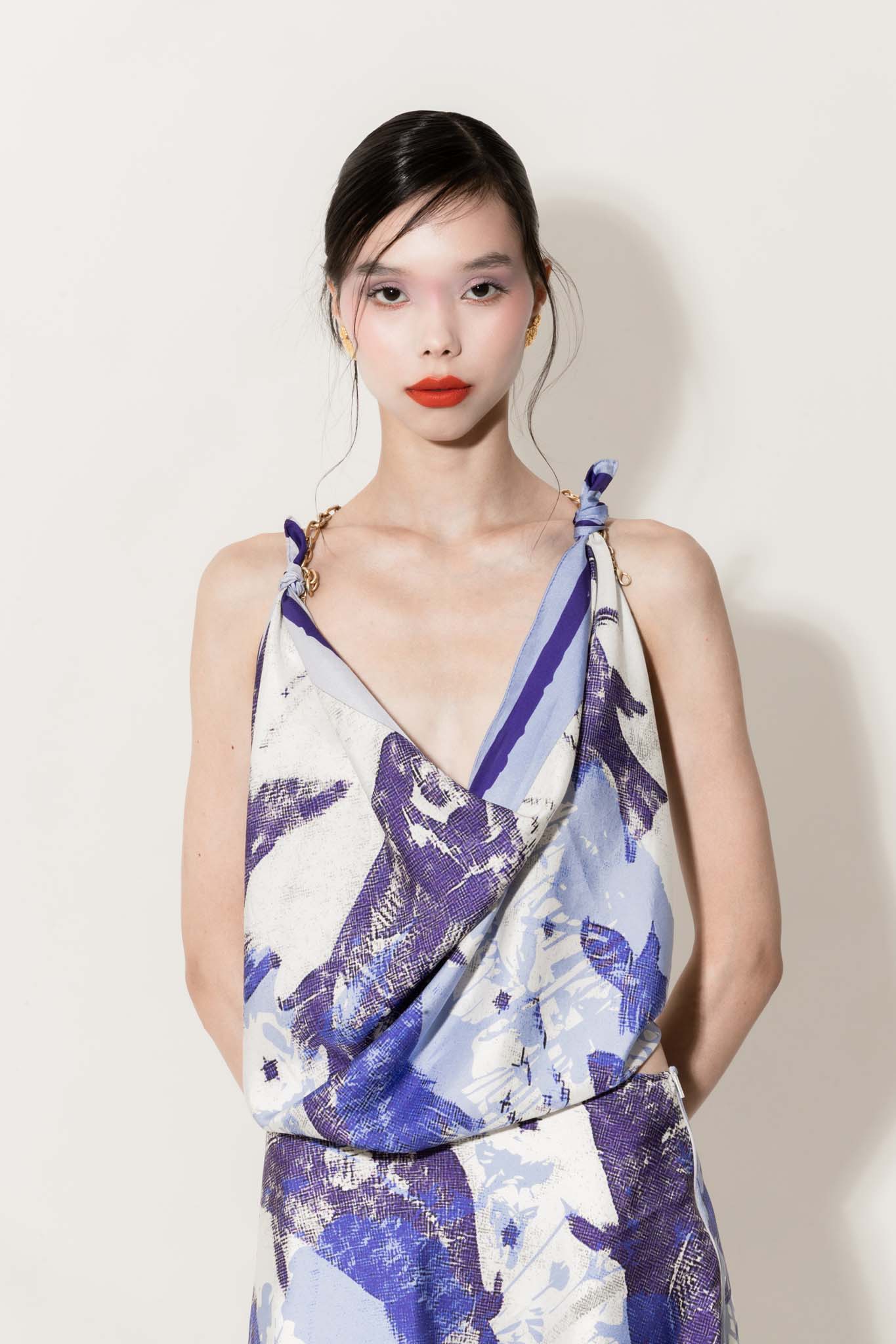 Woman wearing a silk scarf as a top and matching asymmetrical skirt