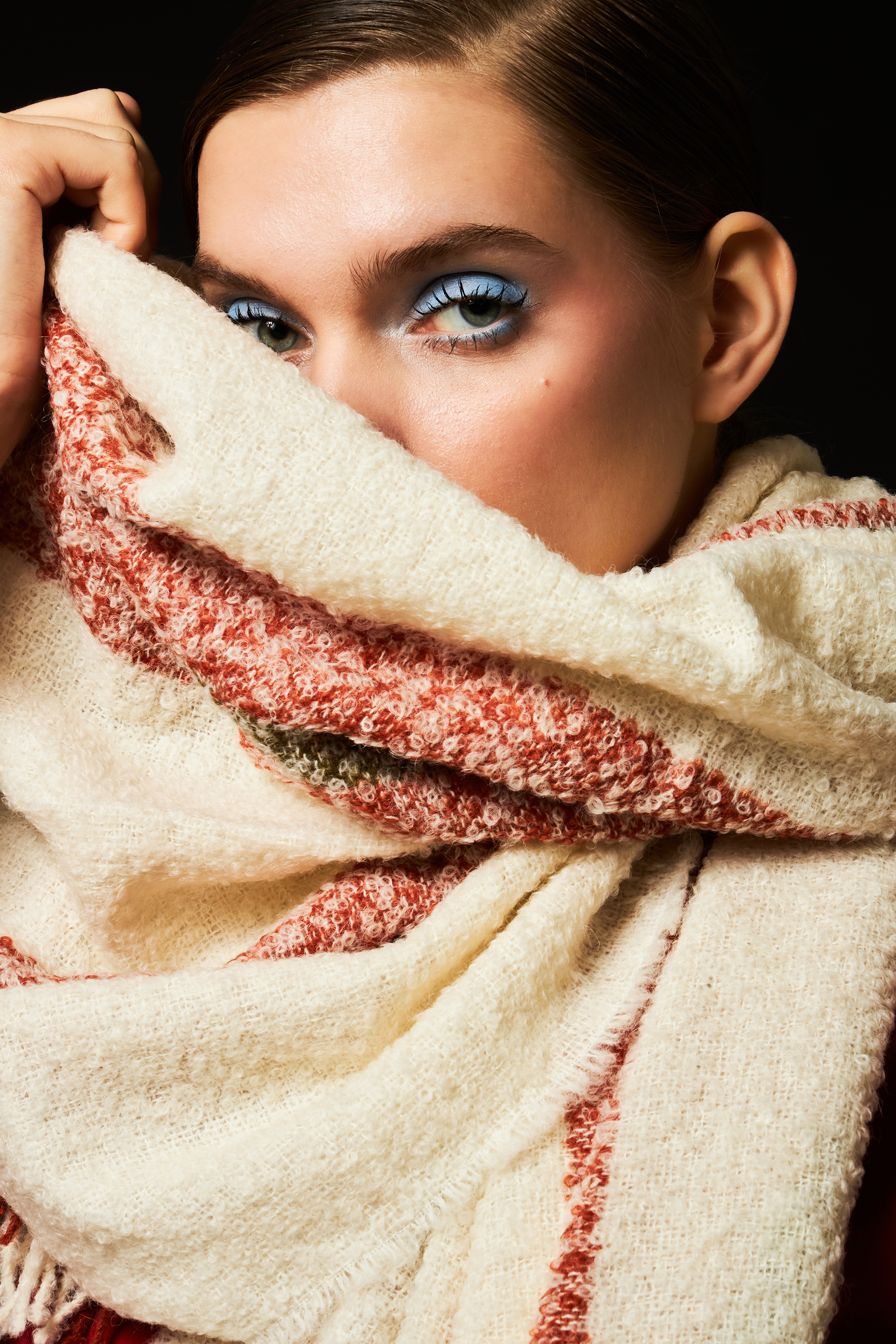 Person wrapped in a white alpaca wool scarf with a close-up of their face.