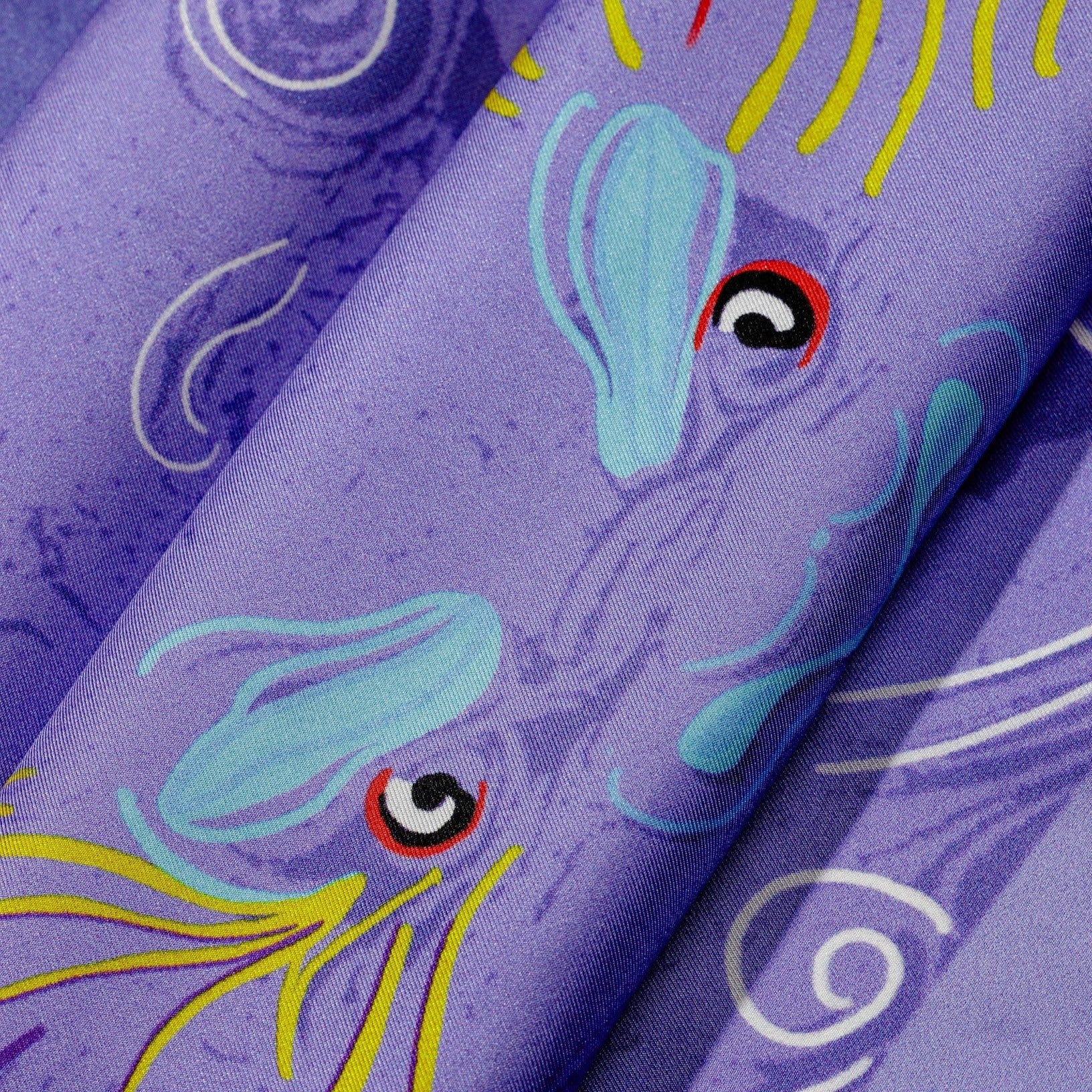 zoom on silk twill fabric. purple dragon design print