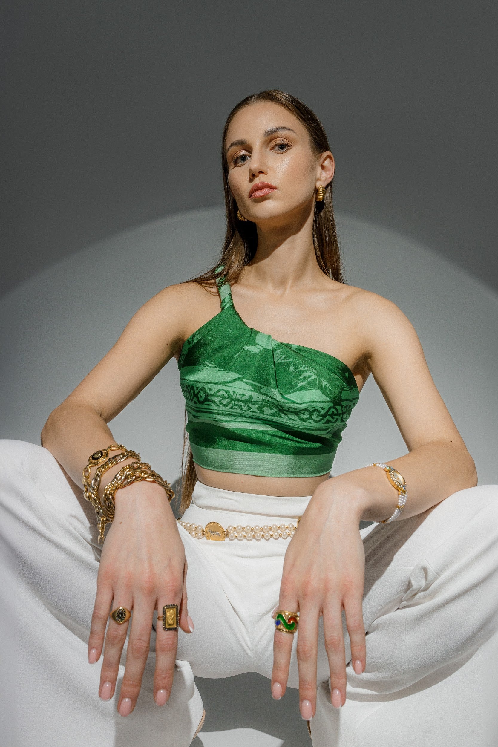 Model wearing silk twill square scarf  with green print as a top 