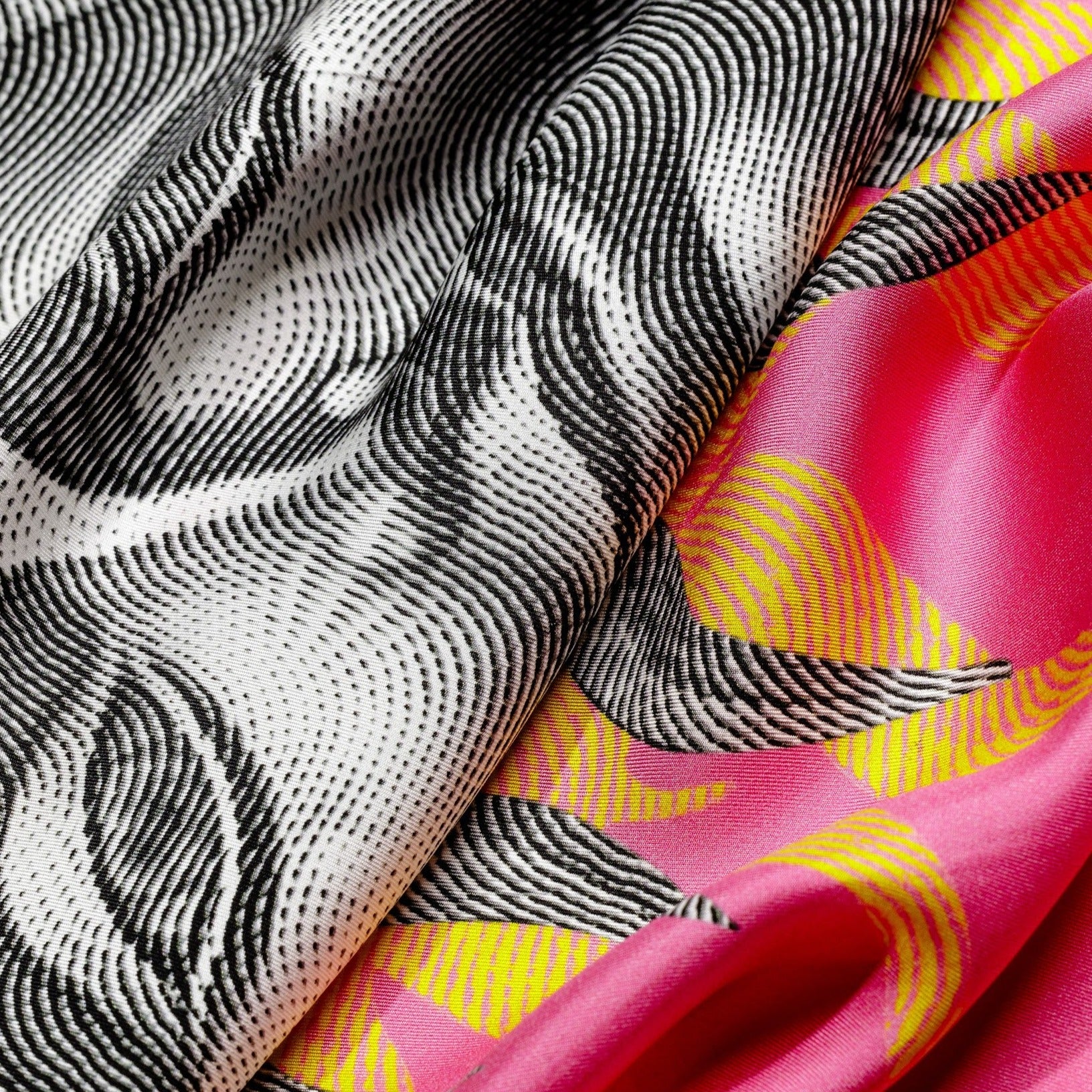 Zoom on silk twill fabric with sun print in bright colors