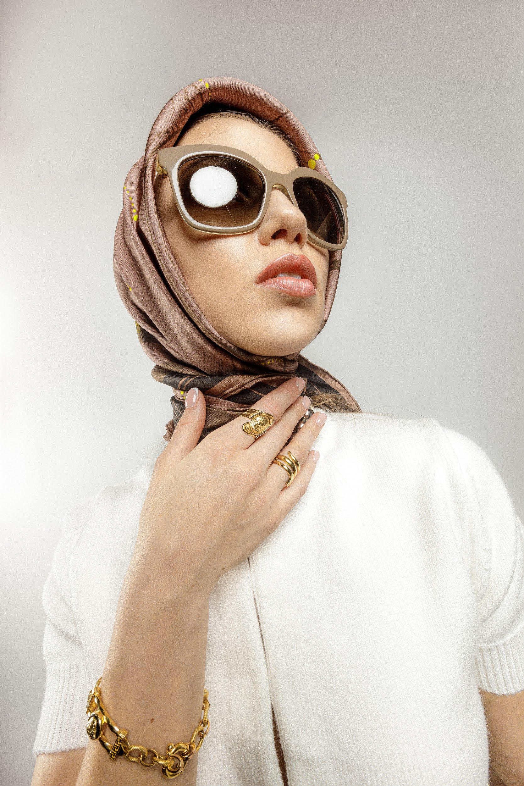 Model wearing brown silk twill square scarf as headscarf