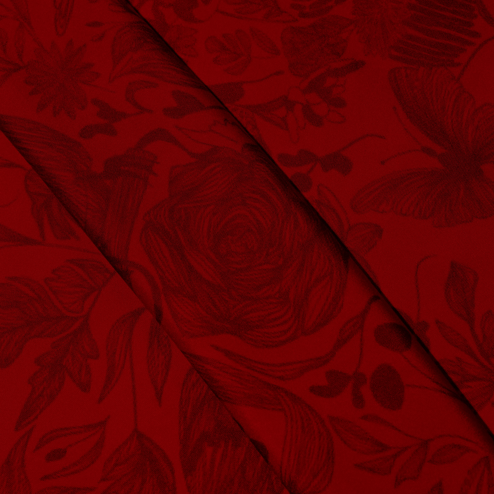 Zoom on silk twill fabric with print drawing nature in red